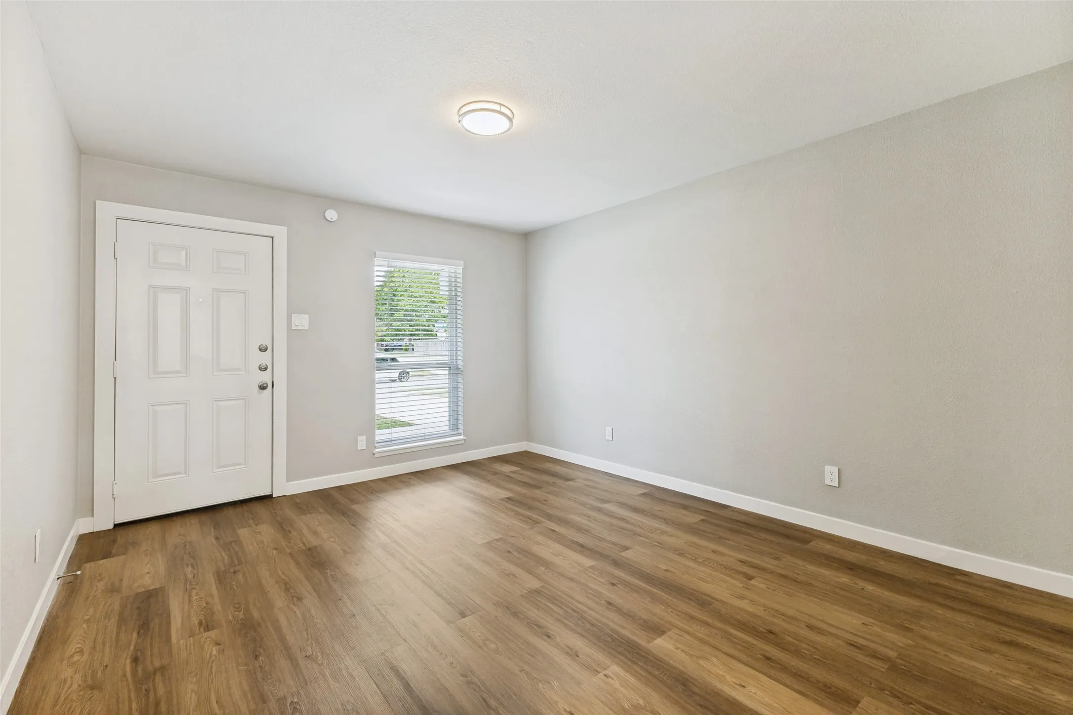 Step inside to the living area, it's got fresh paint and awesome floors!