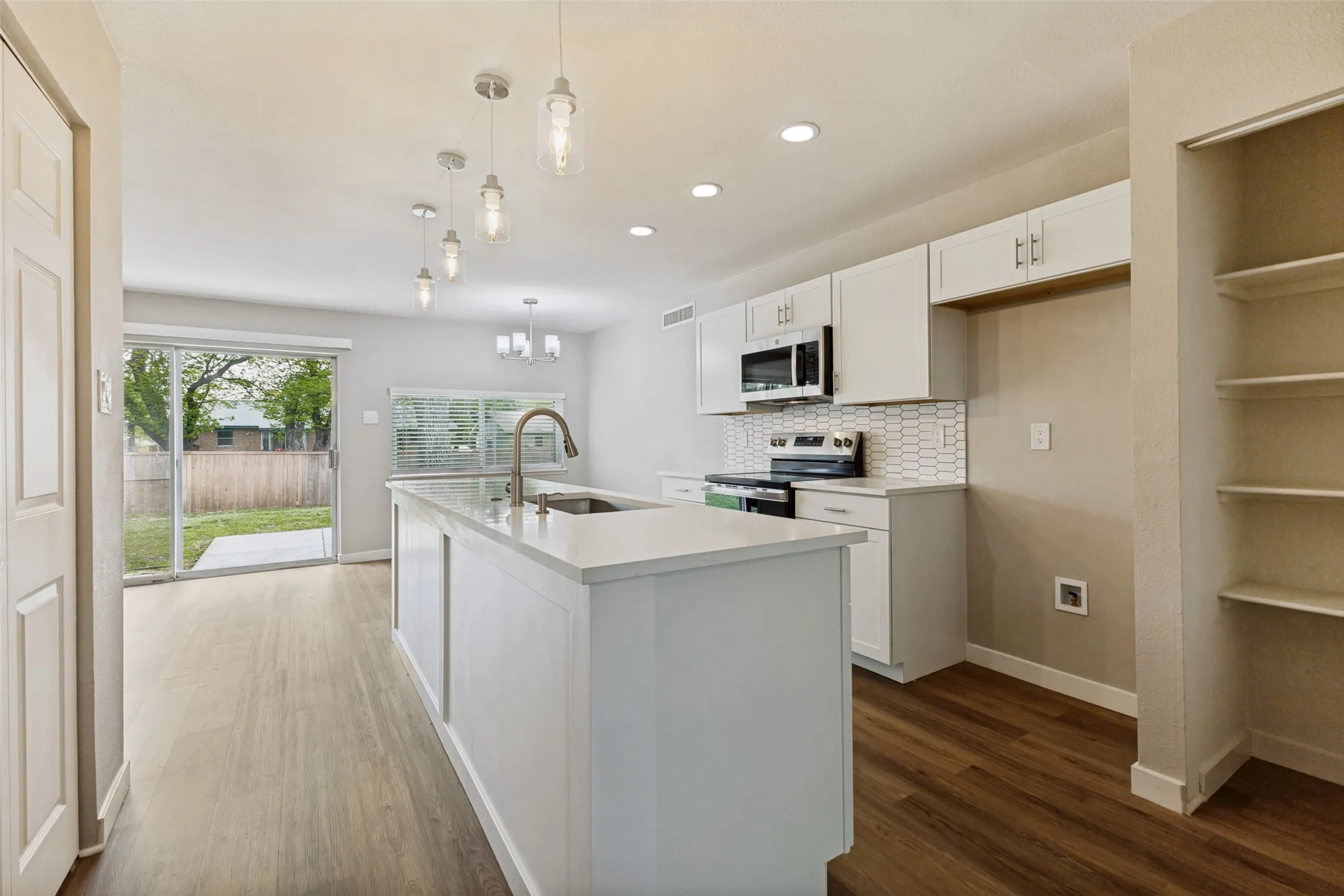 So clean, fresh, and inviting! Love the huge center island.