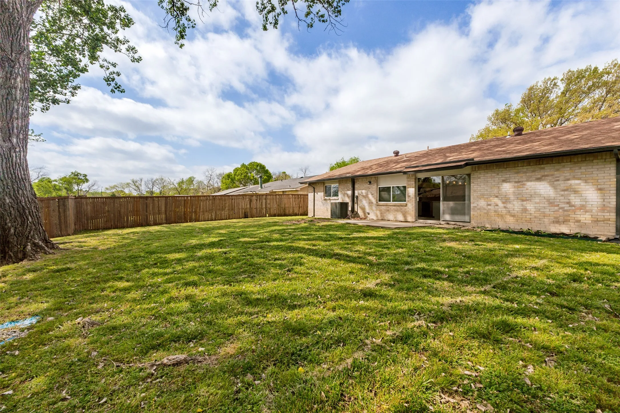 The backyard is enhanced by a magnificent mature tree that provides ample shade, creating a cool and comfortable retreat during warm afternoons.