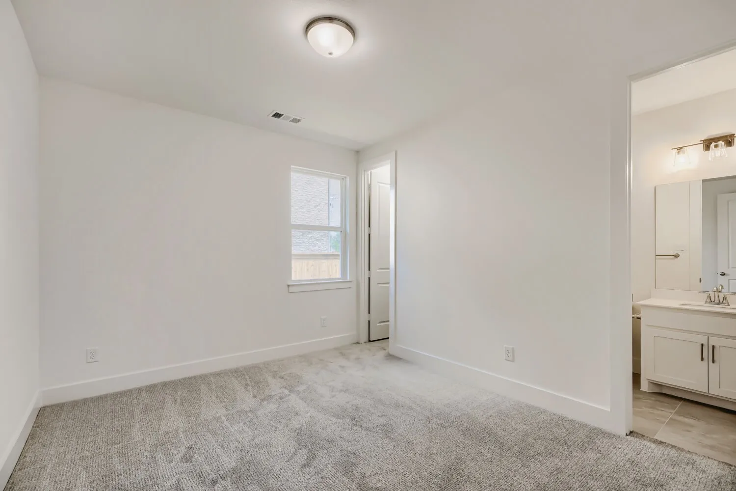 Carpeted room with white walls, a single window, and a flush mount ceiling light