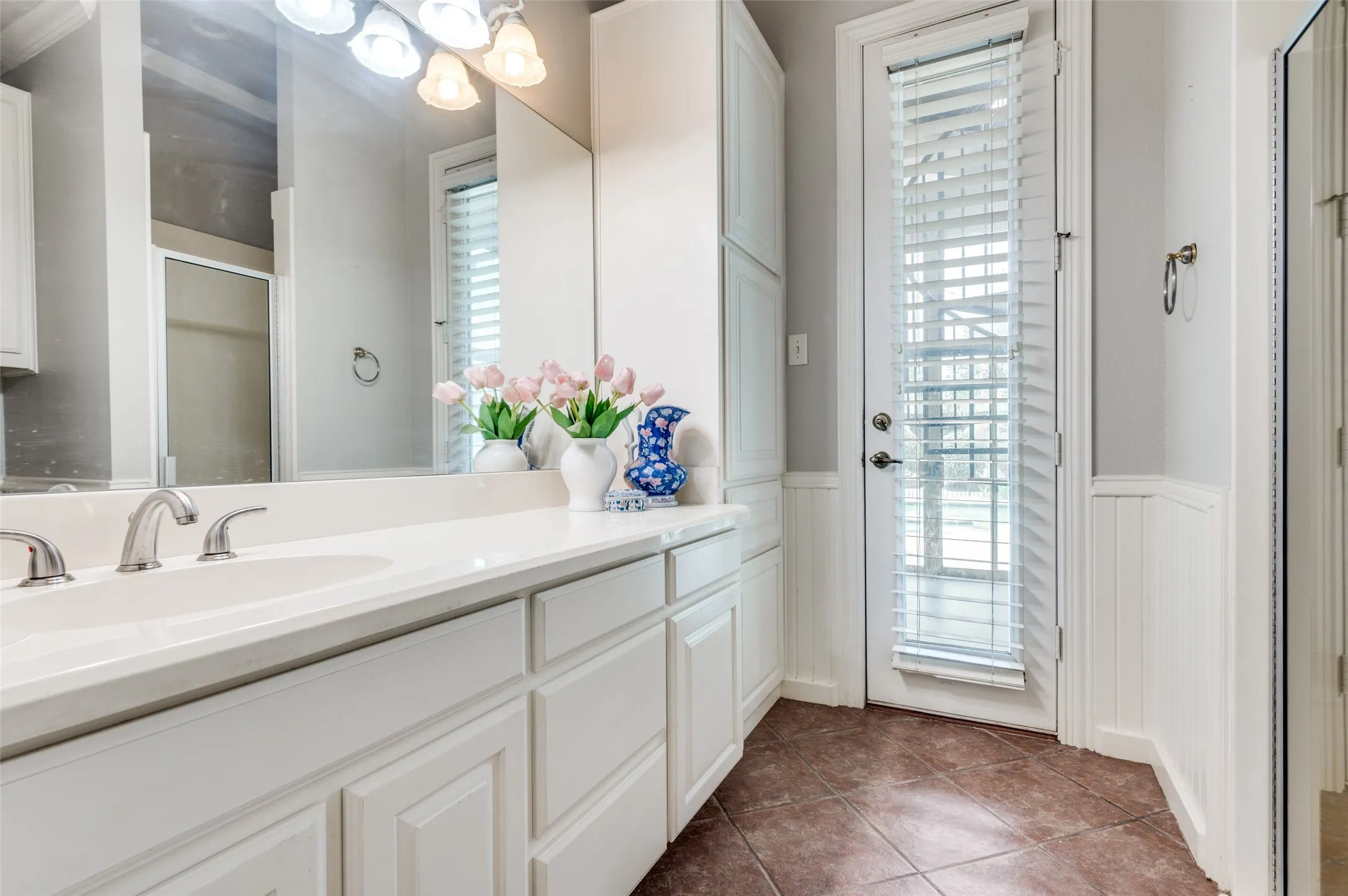 full bath off the kitchen leads to patio