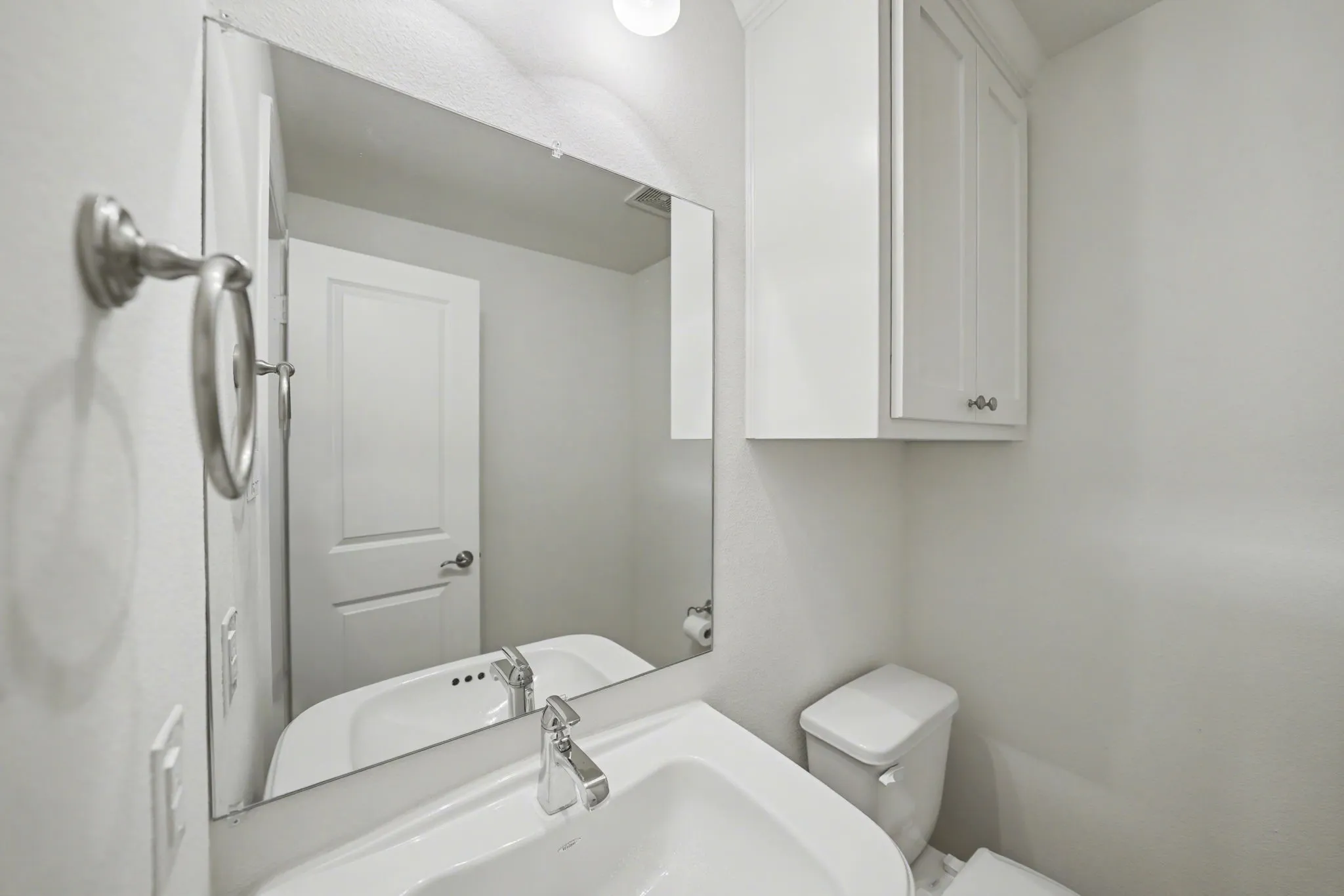 Half bath downstairs with toilet and a sink