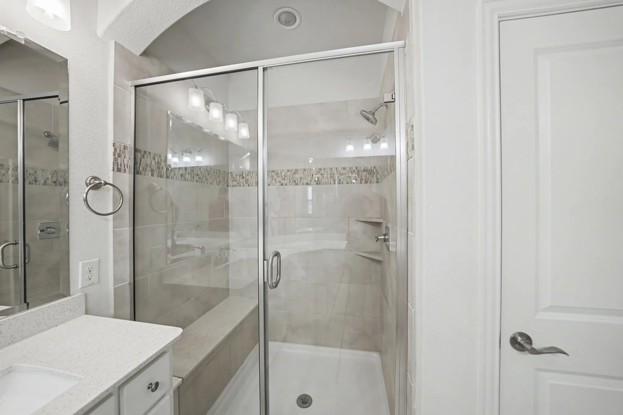 Full bath with vanity and a shower stall