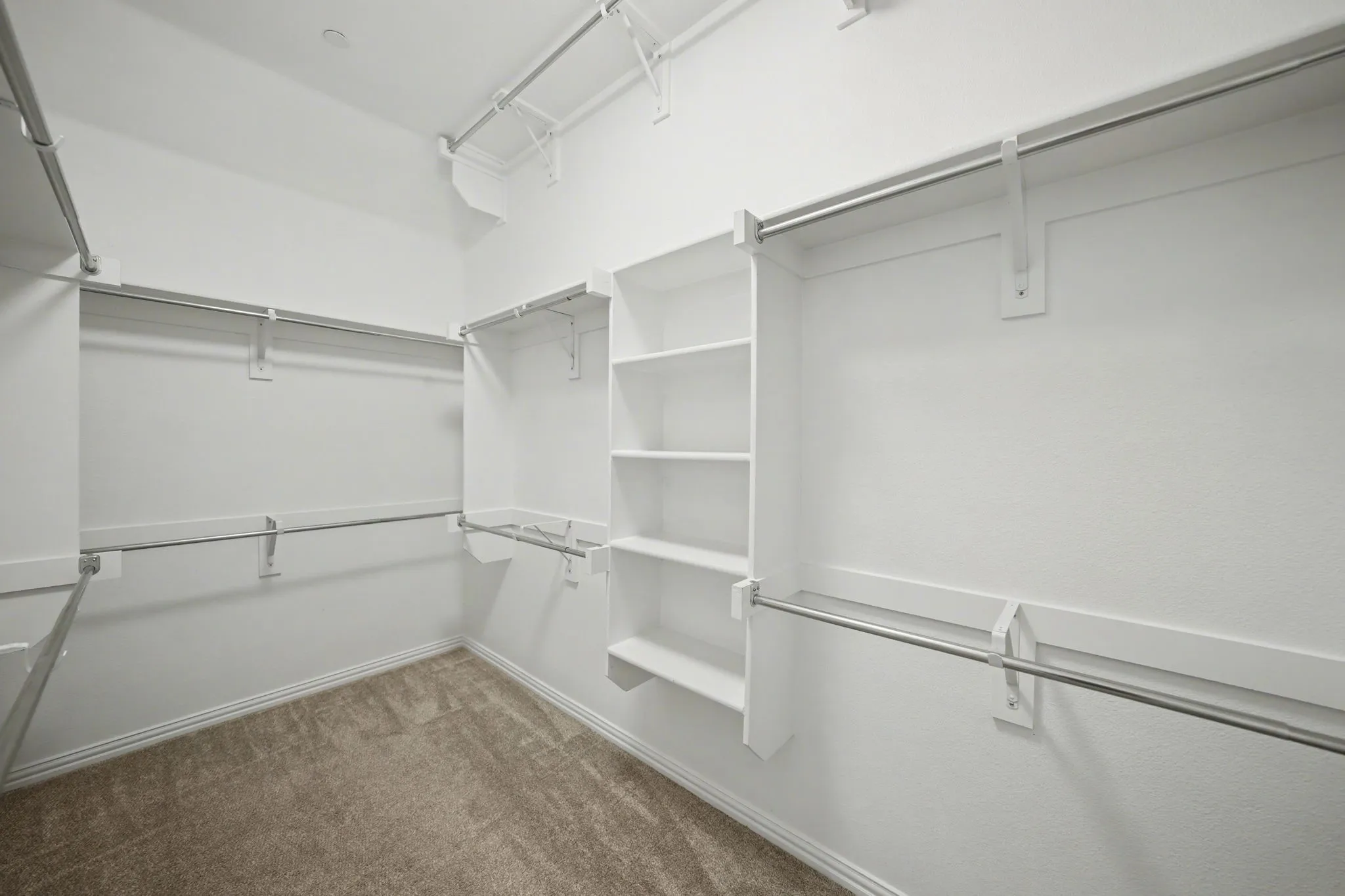 Walk in closet with dark carpet