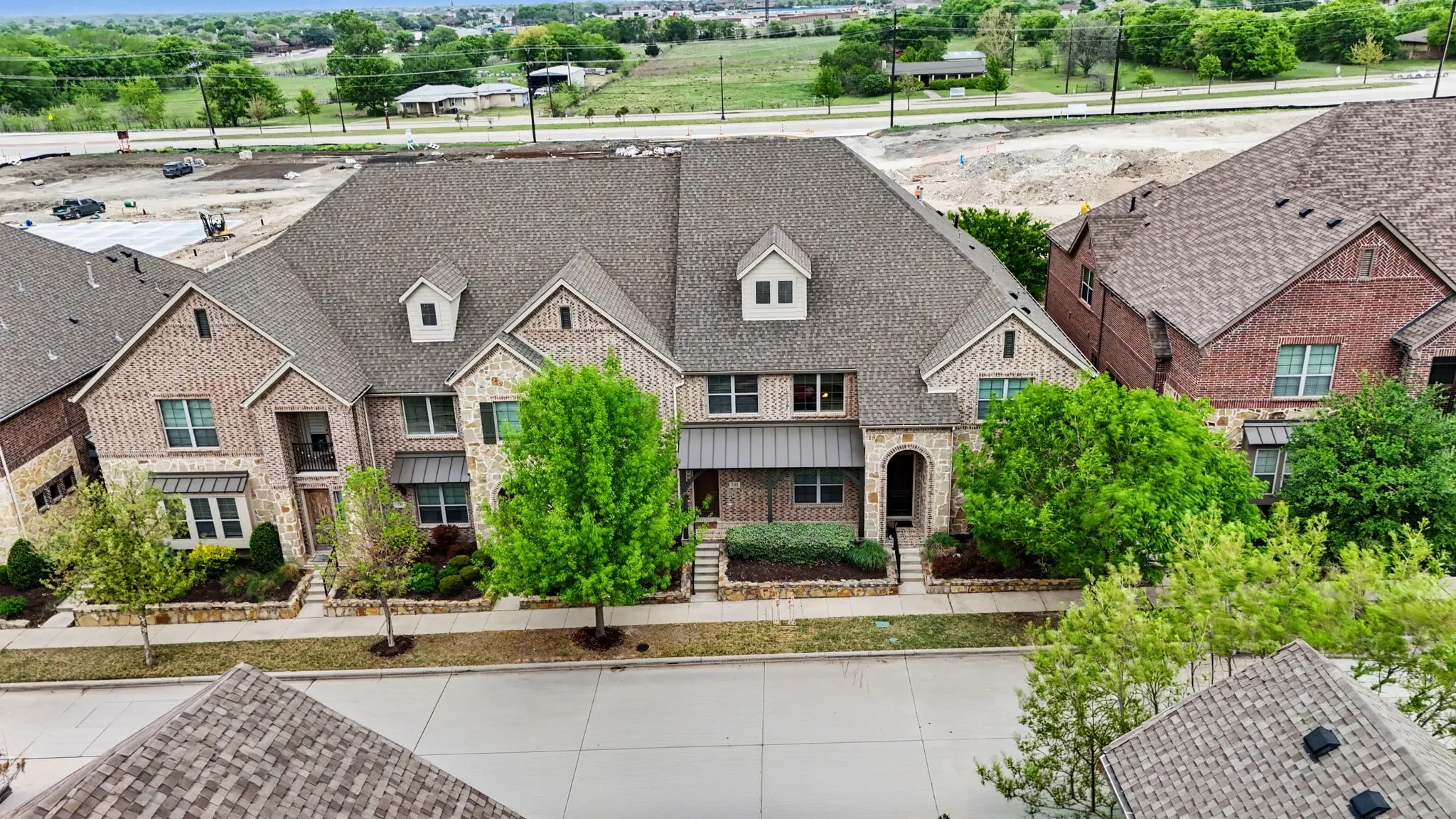 View of front facade featuring brick siding and stone siding