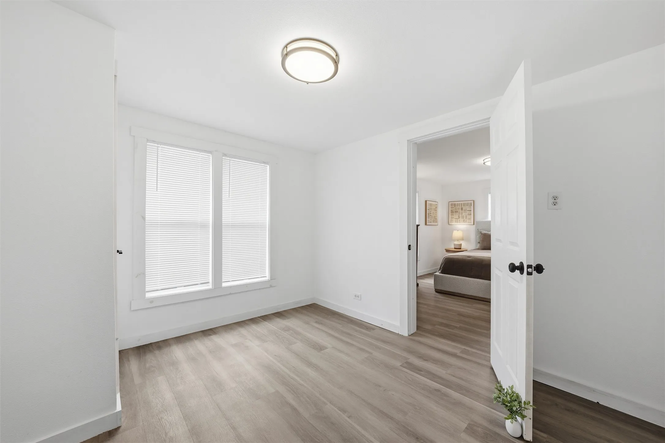 Spare room featuring baseboards and light wood-style floors