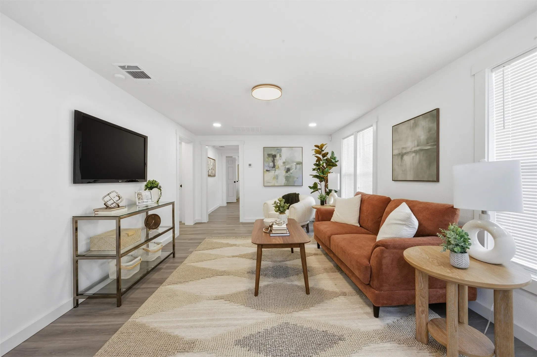 Living room with baseboards and light wood-style flooring
