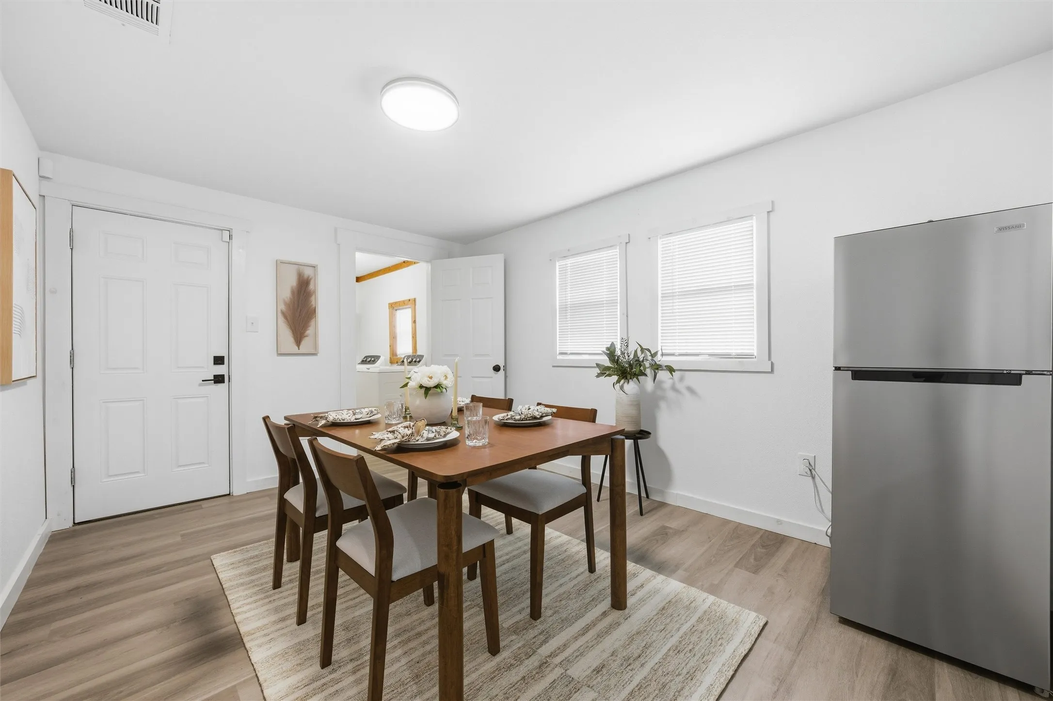Dining area featuring light wood-type flooring and baseboards