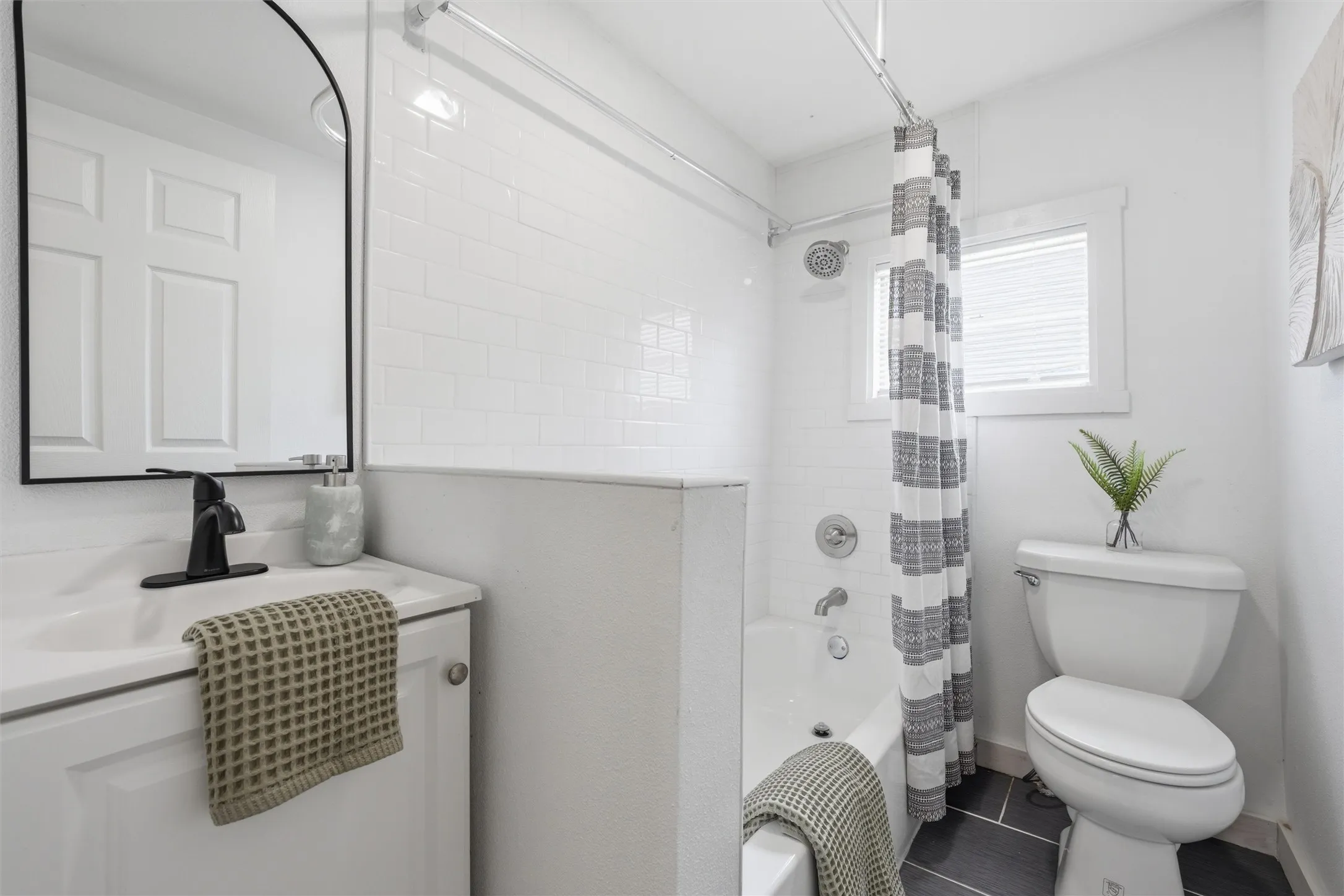 Bathroom with shower / tub combo with curtain and vanity