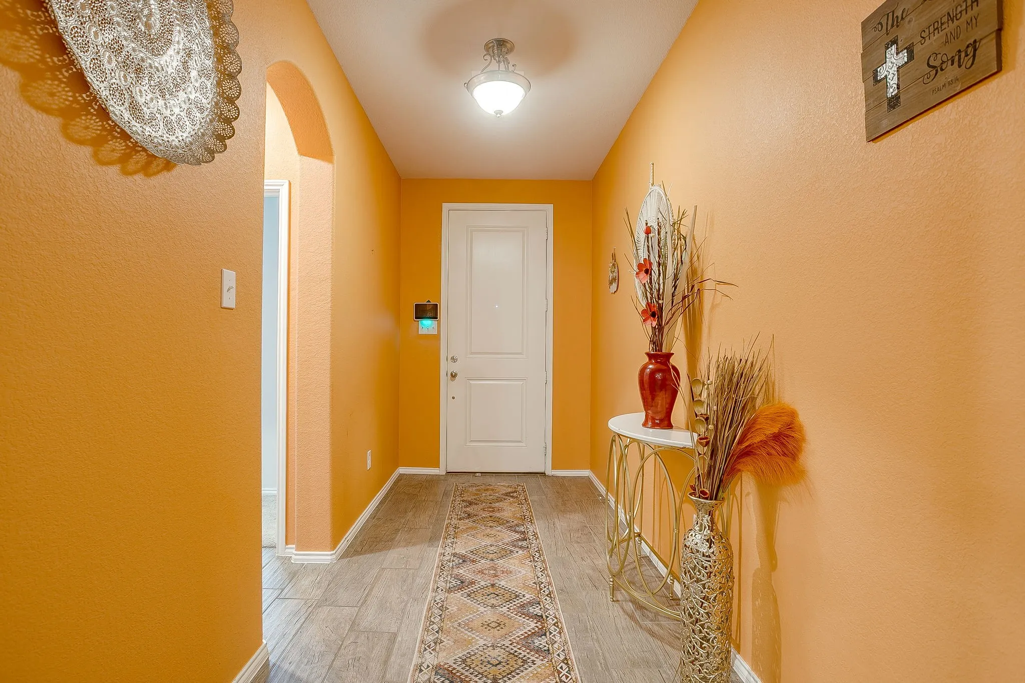 Tall ceilings in entryway and beautiful wood look flooring!