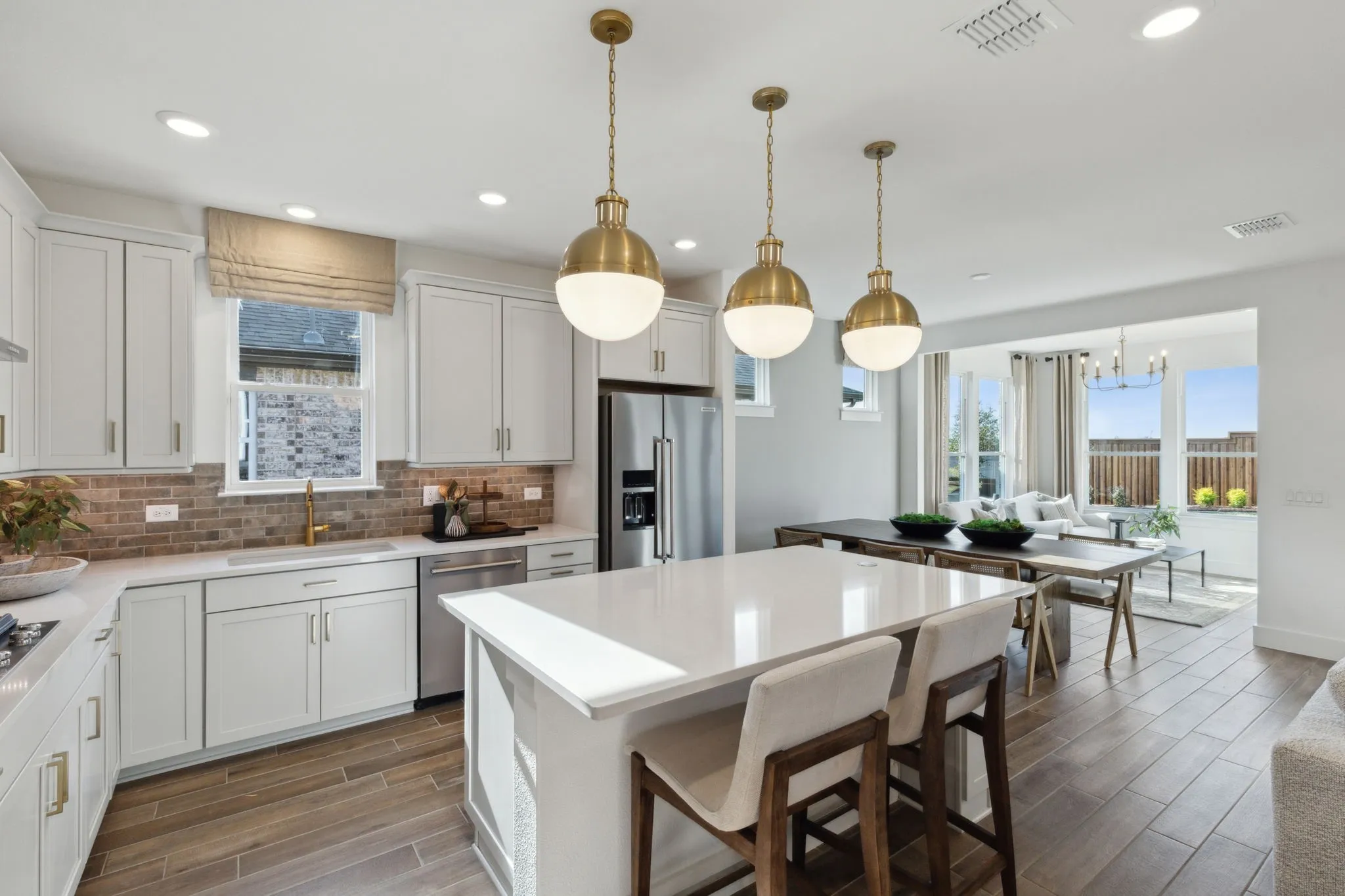 *Model Representation - Large island overlooking gathering room and dining areas