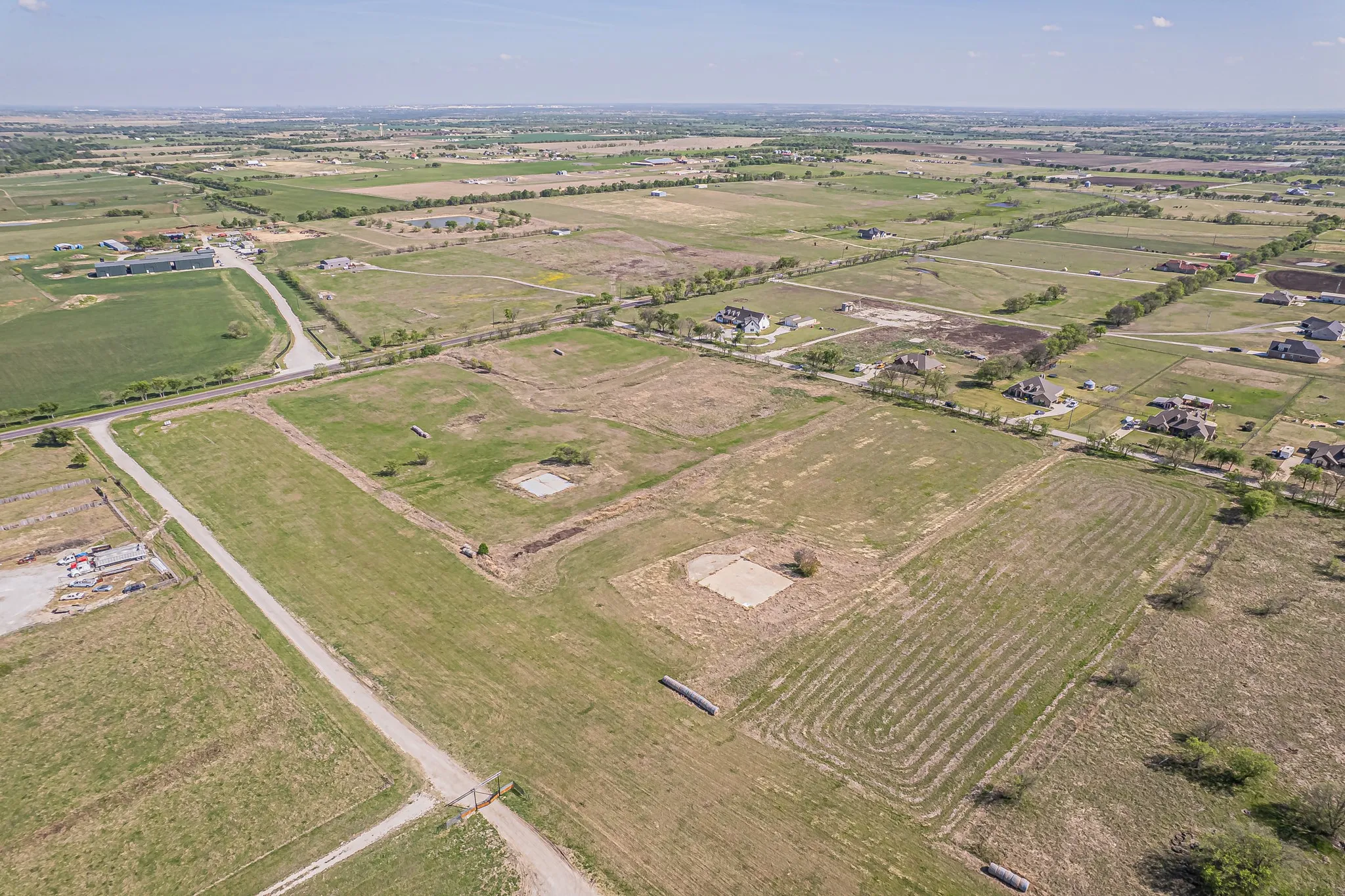 Aerial overview of property's location featuring rural landscape and rows of crops