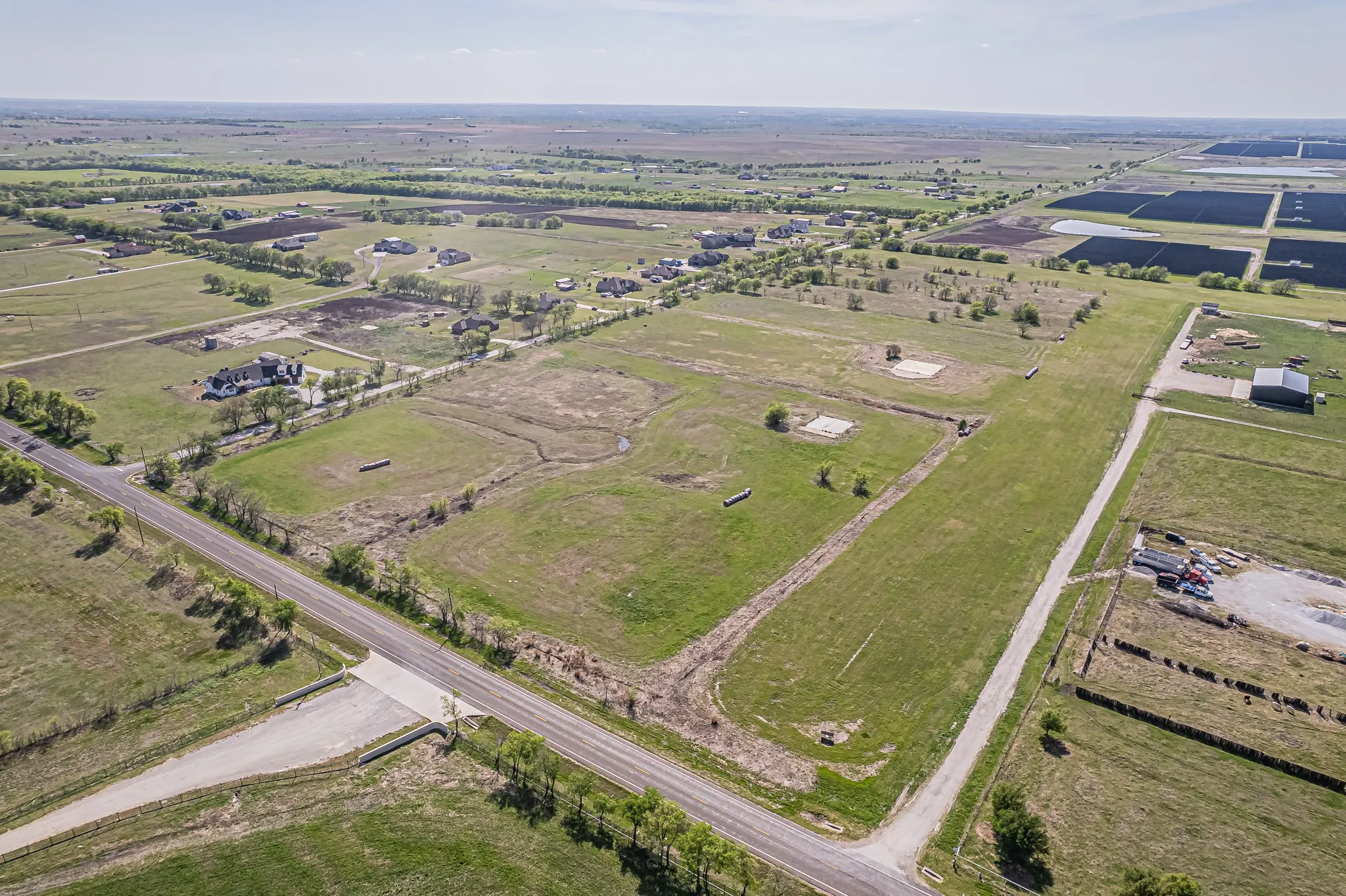 Aerial view of property's location featuring rural landscape and farmland