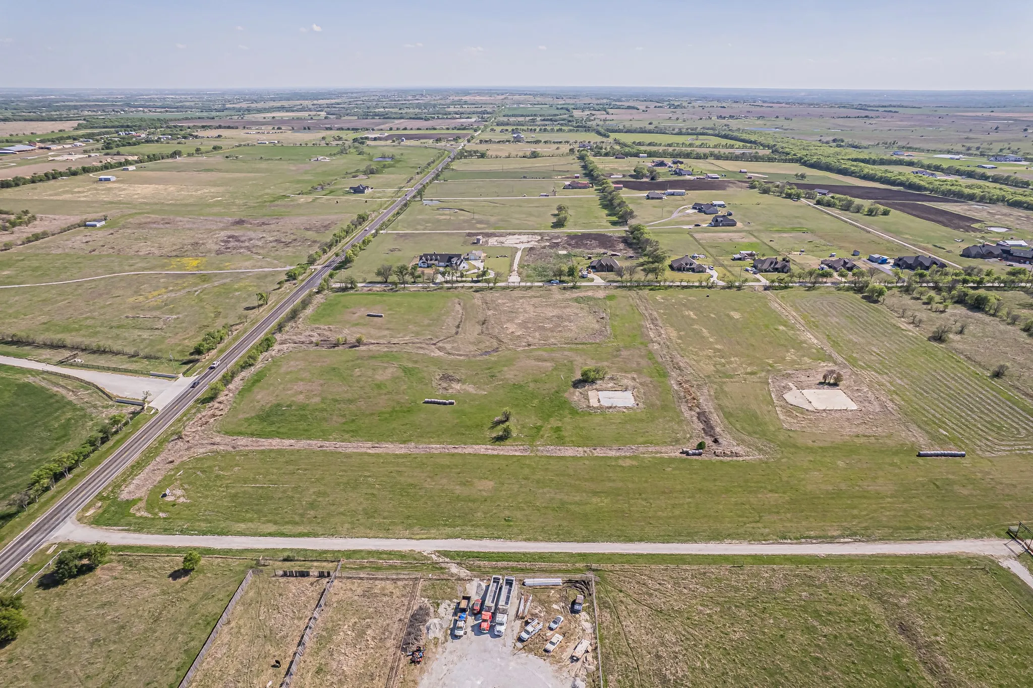 Aerial overview of property's location with rural landscape and extensive farmland