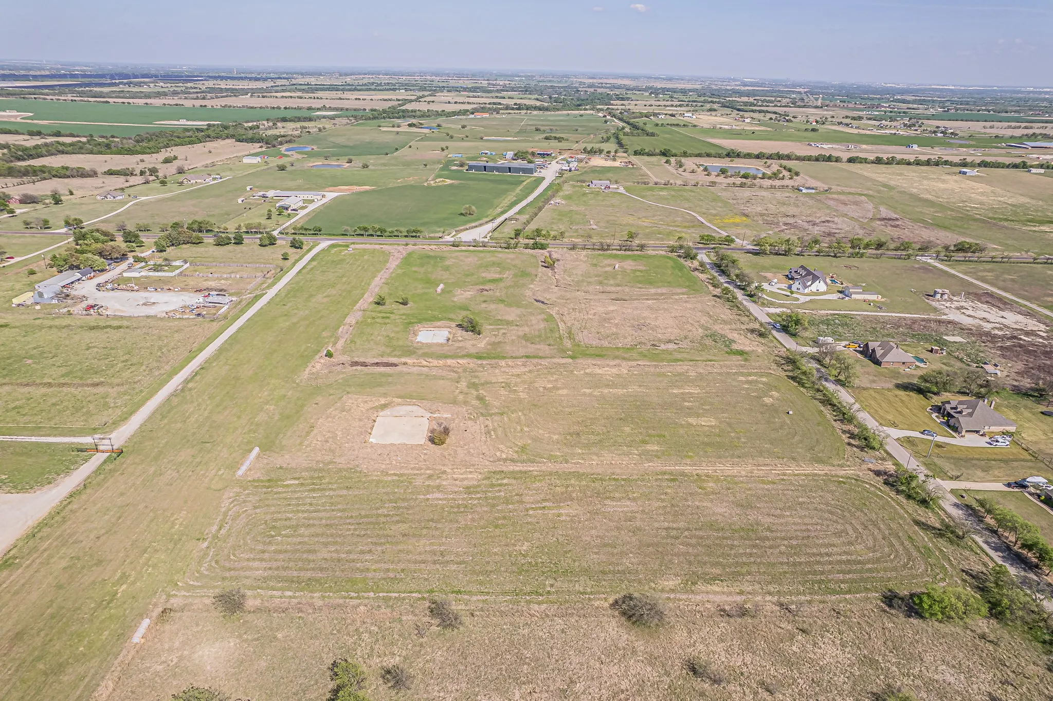 Aerial view of property's location with rural landscape and large plots for crops