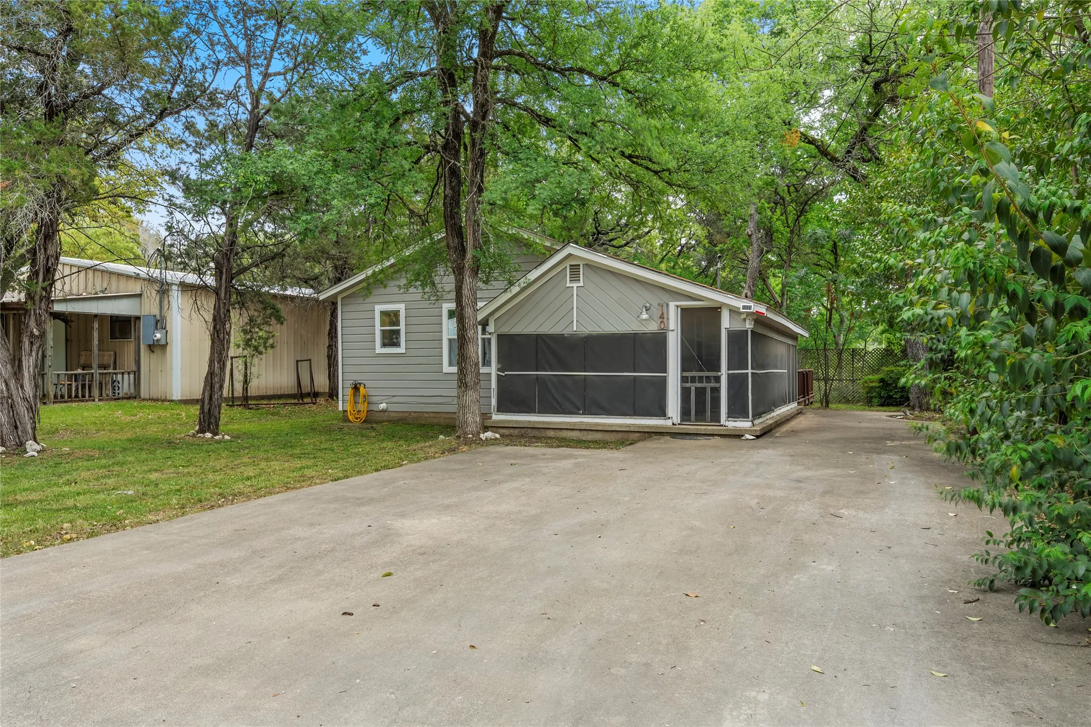 View of front of home featuring a sunroom and a front lawn