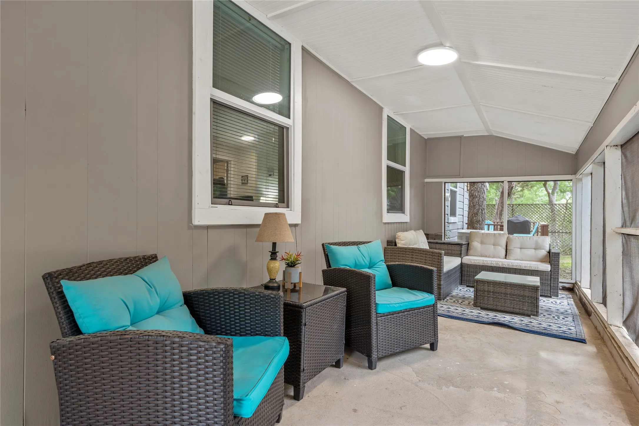 Sunroom with an outdoor living space, vaulted ceiling, and a patio