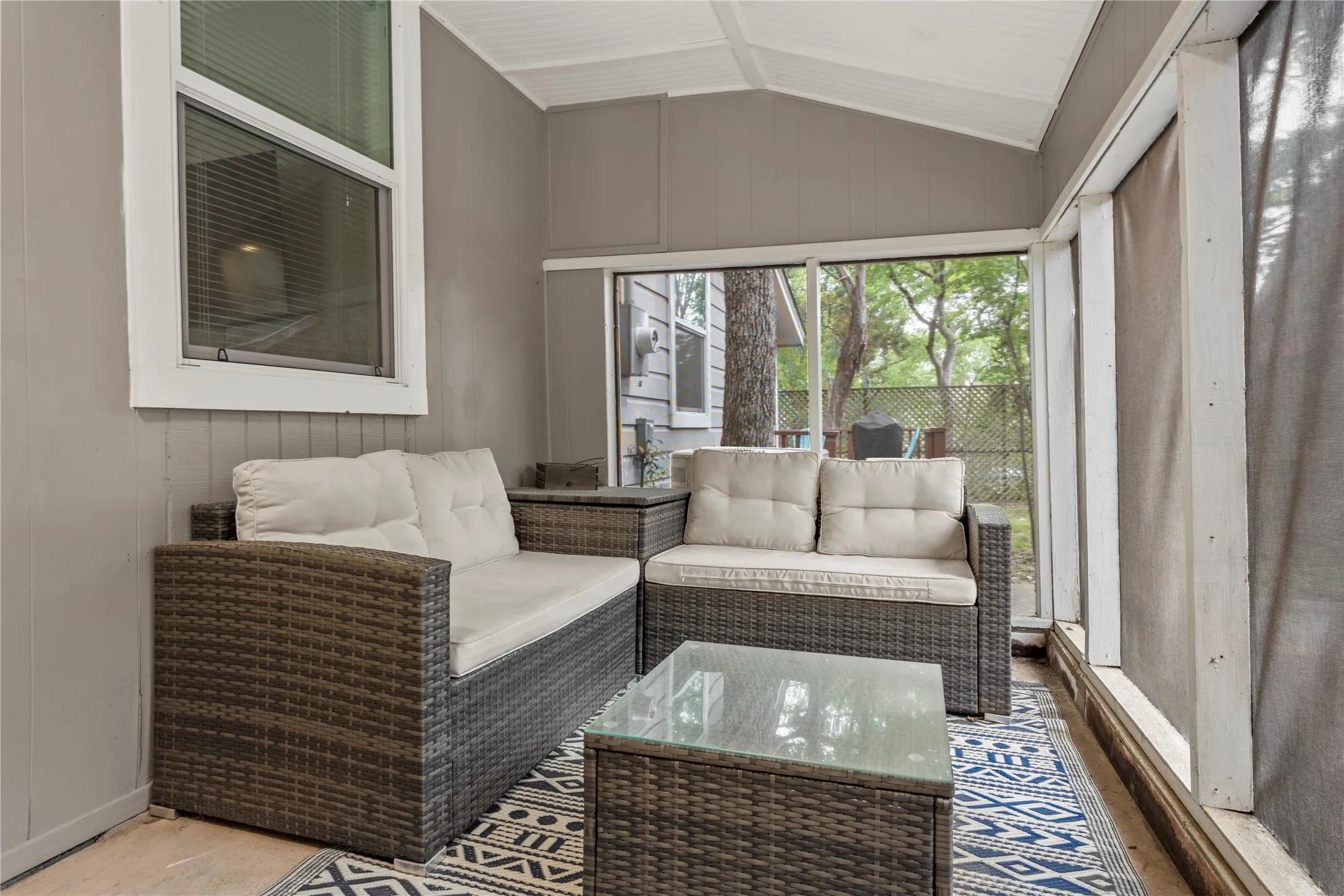 Sunroom featuring lofted ceiling and an outdoor hangout area