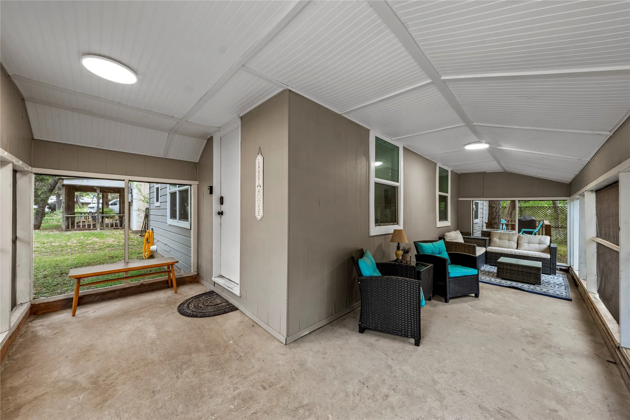 Sunroom featuring vaulted ceiling, a patio, and an outdoor living space