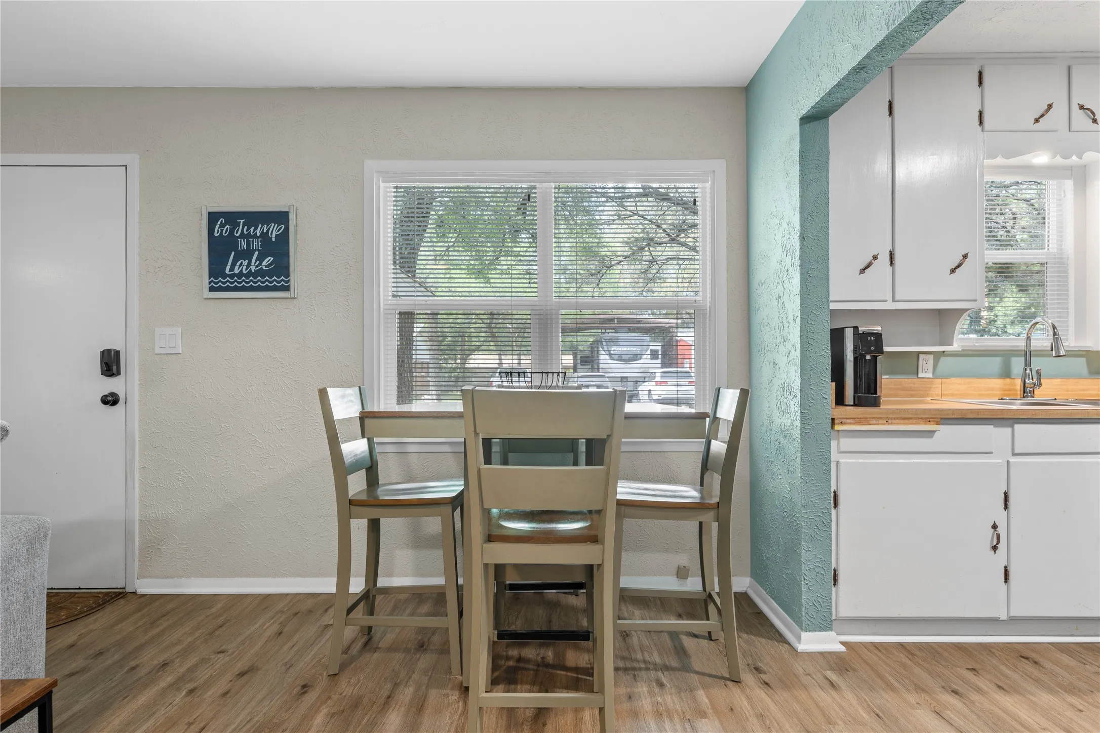 Dining room featuring a textured wall and light wood finished floors