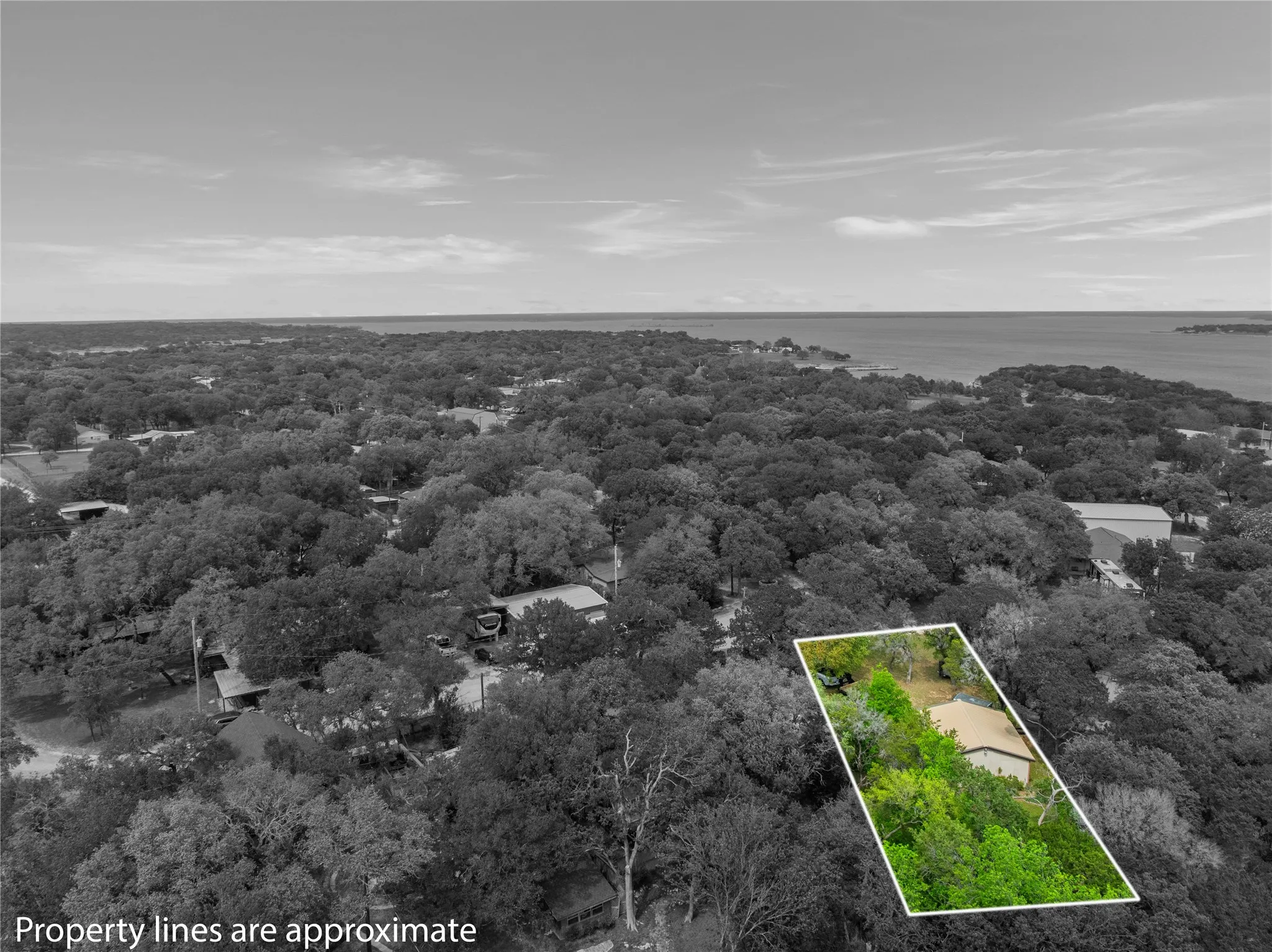 Aerial view of property's location featuring property parcel outlined and a nearby body of water