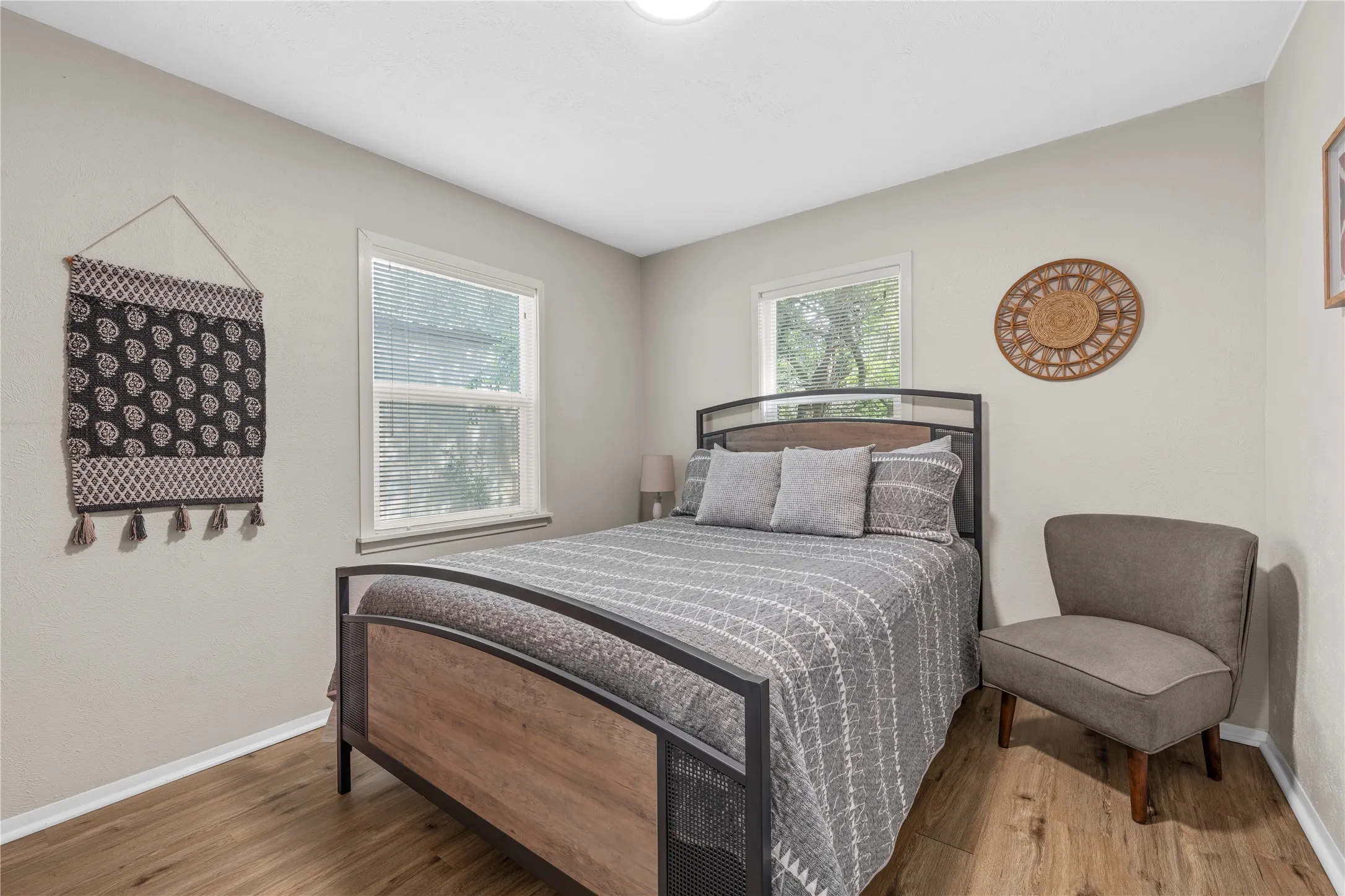 Bedroom featuring multiple windows and light wood-type flooring