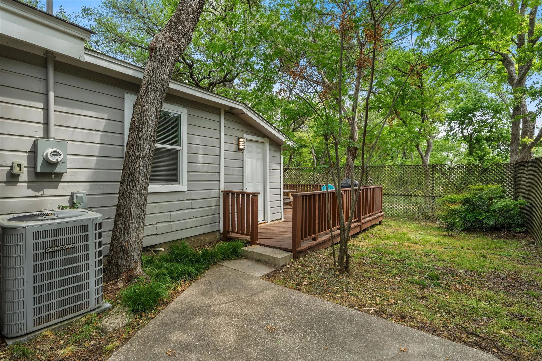 Fenced backyard with a deck
