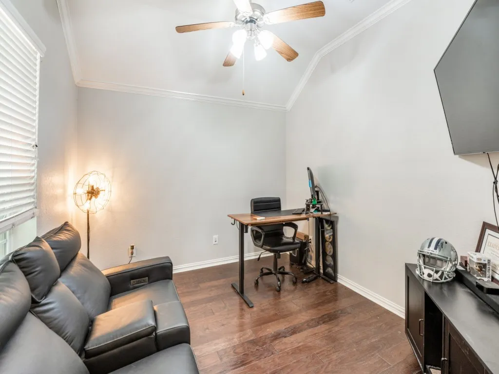 The home office offers an impressive view of the neighborhood, and the vaulted ceilings enhance the sense of spaciousness in the room.