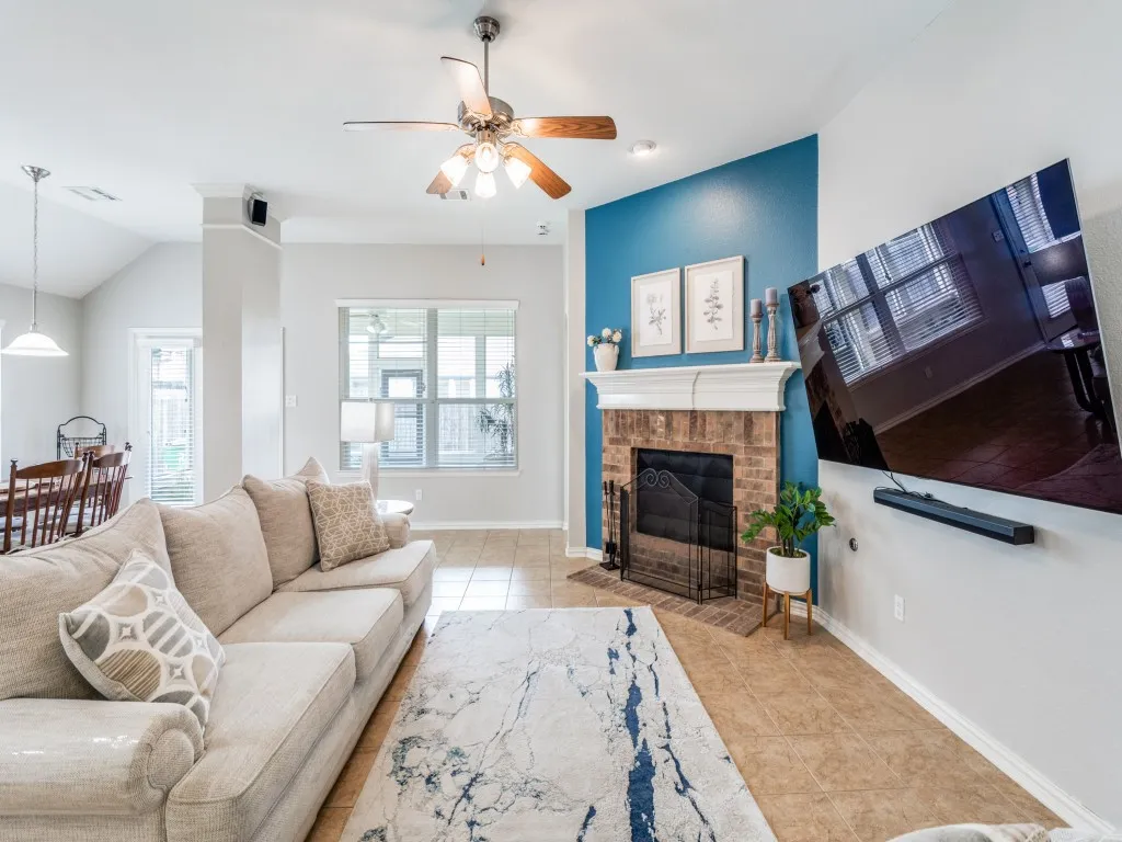 The living room offers far more space than many modern homes, easily accommodating large couches as shown in the photo.