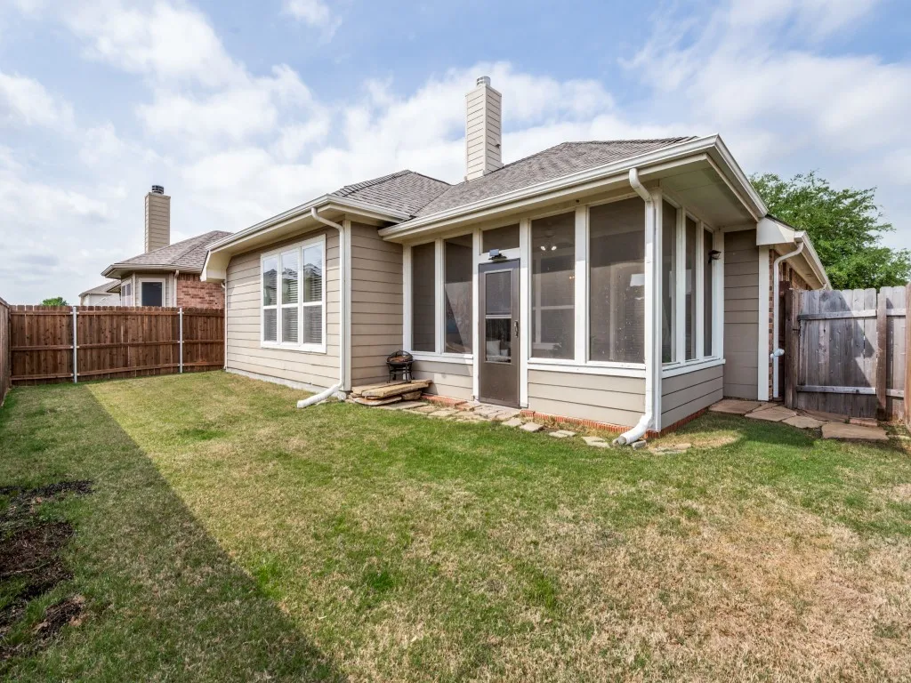 This backyard provides sufficient grass for pet owners while also requiring minimal maintenance.