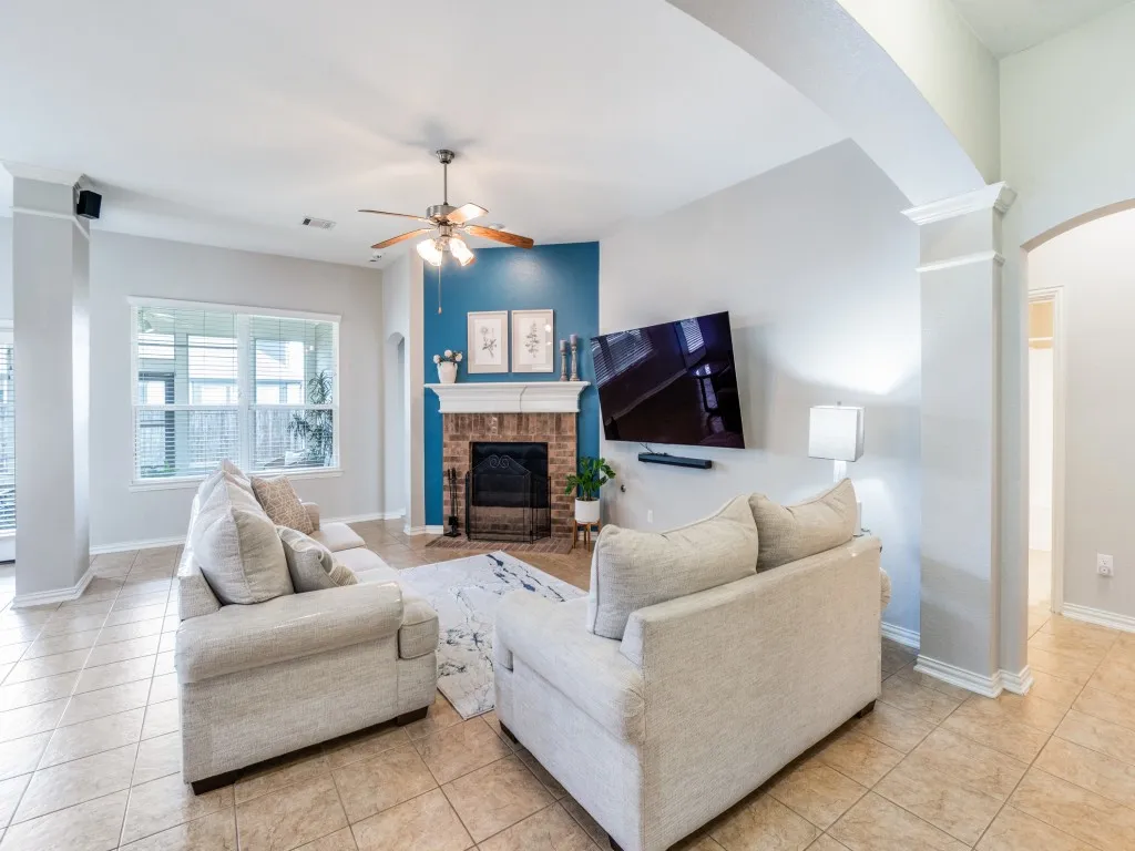This fireplace looks even better in person—the soft blue enhances the neutral living room.