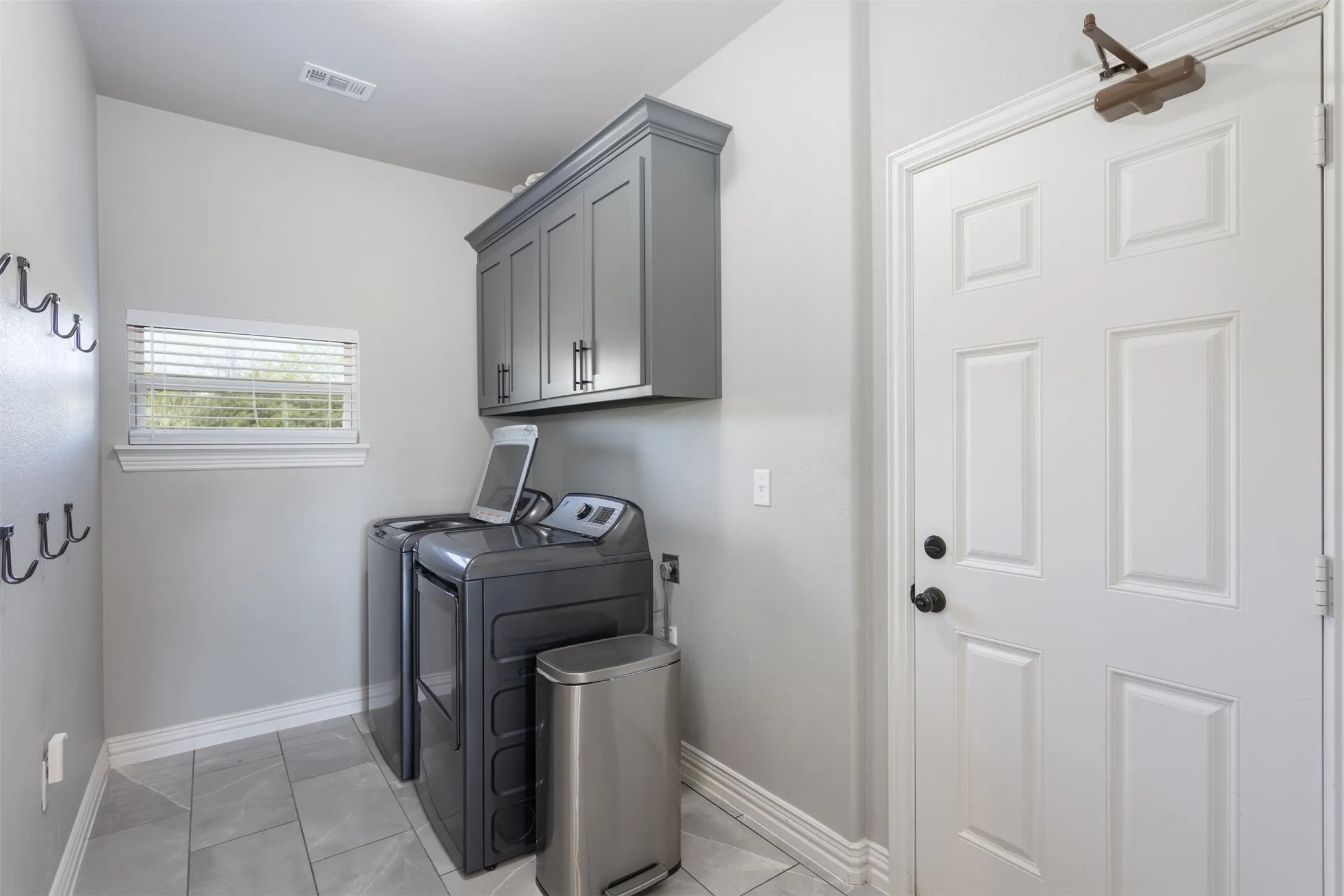 Located off the kitchen, this utility room is located in a perfect spot.