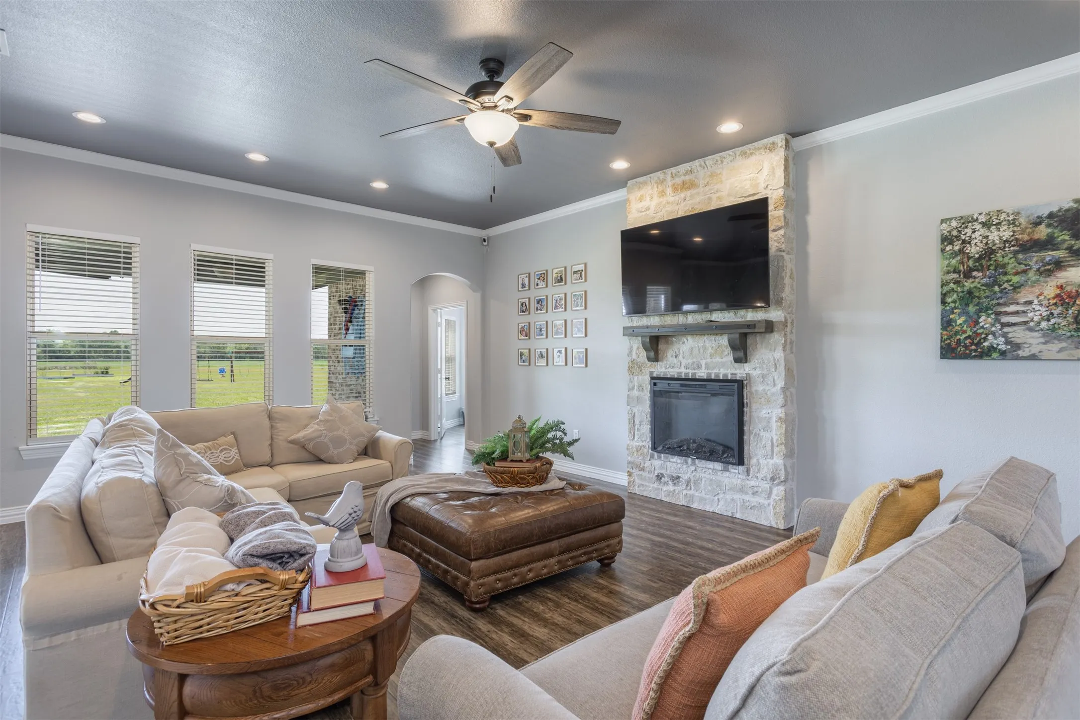 Light and bright, comfy and warming, this family room is anchored by the electric fireplace.  LVP flooring is carried throughout the primary living spaces.