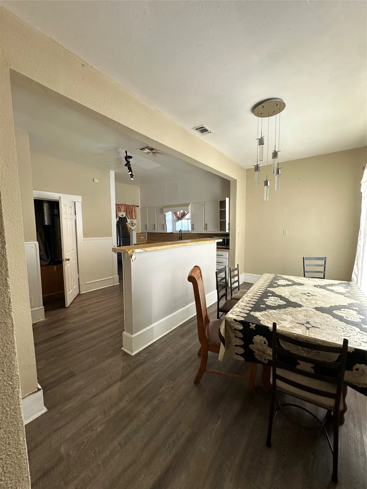 Dining space with dark wood-style flooring