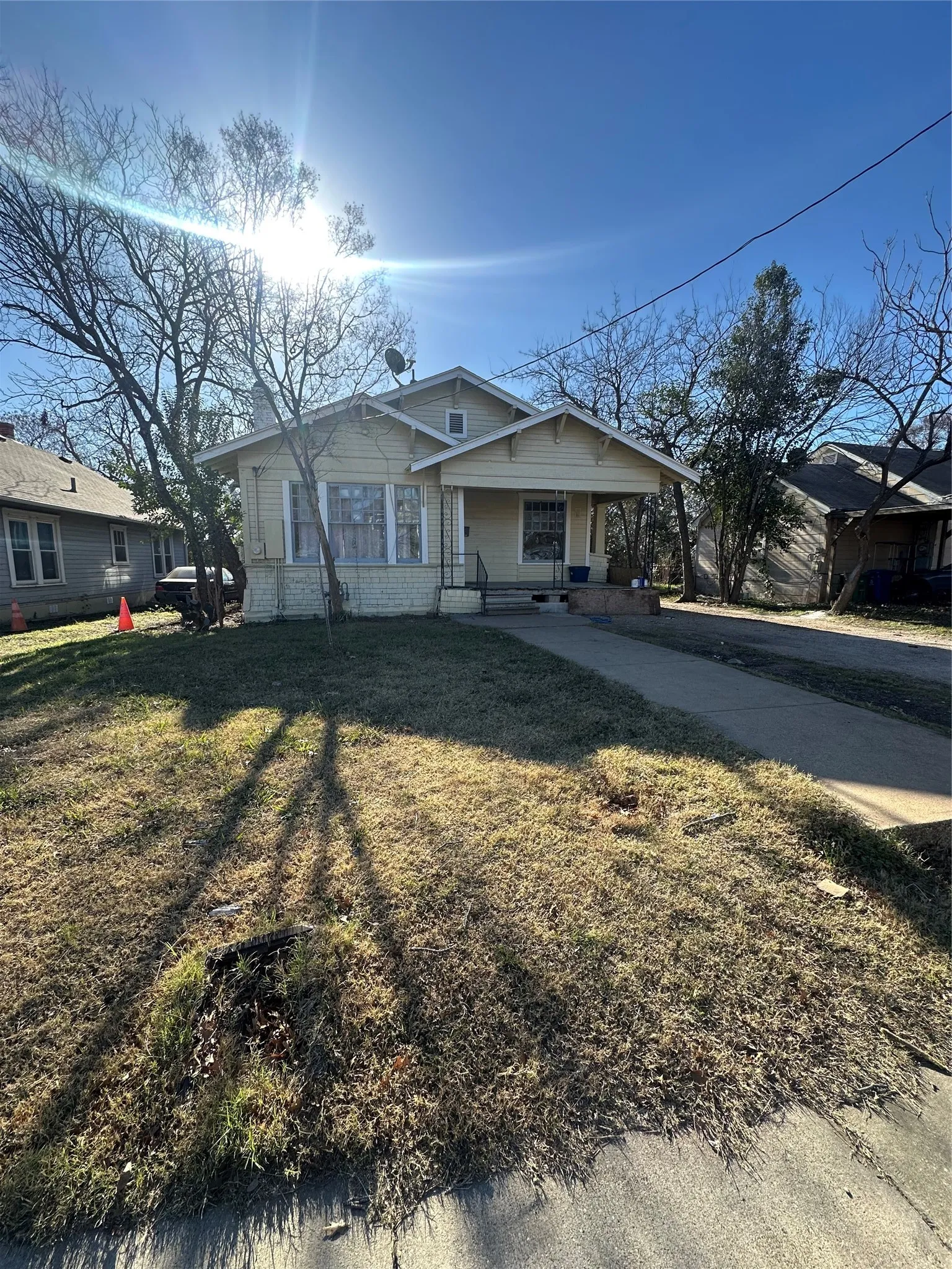 Bungalow-style home featuring a porch and a front lawn