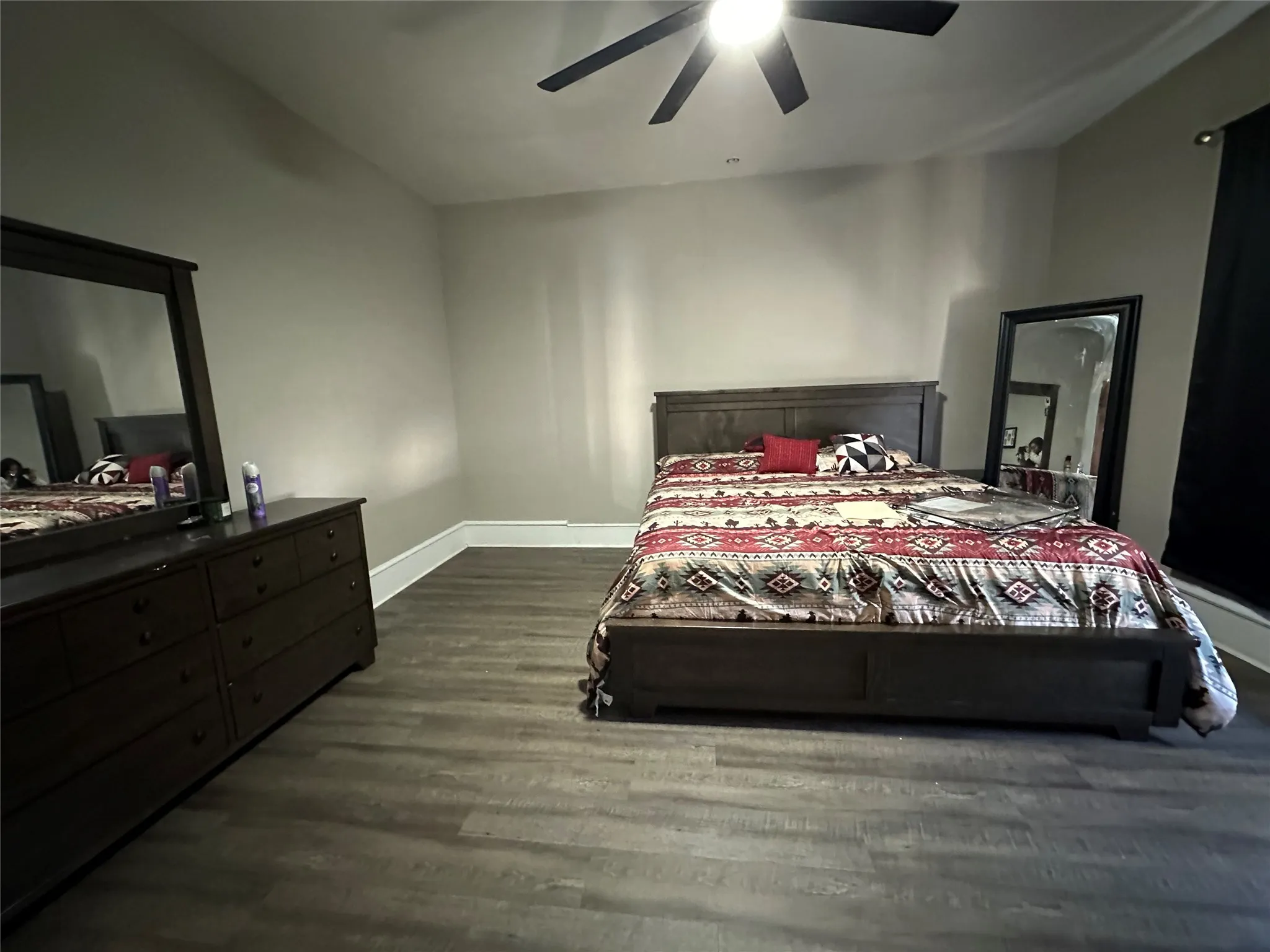 Bedroom featuring dark wood finished floors and a ceiling fan