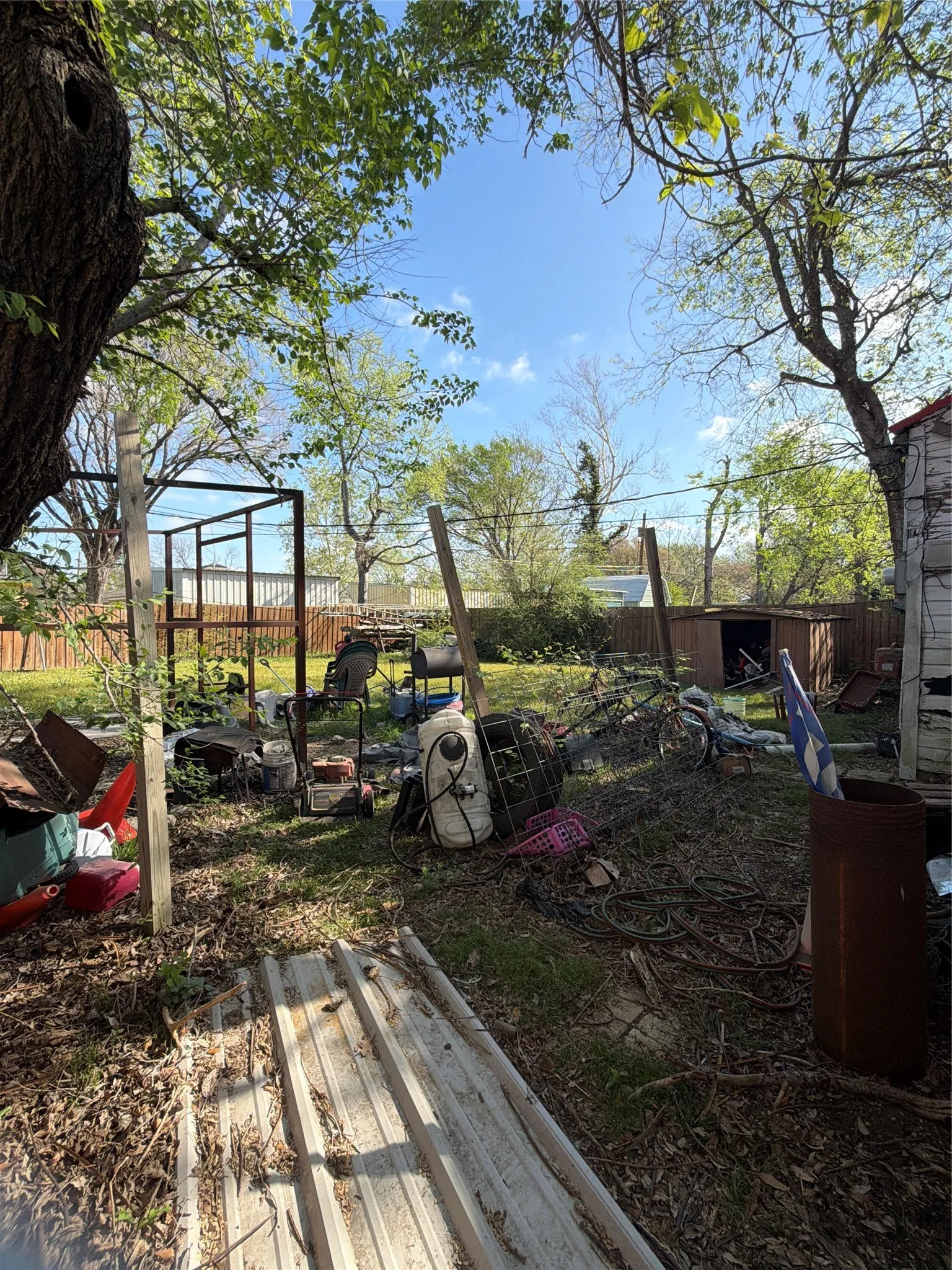 Fenced backyard featuring an outdoor structure