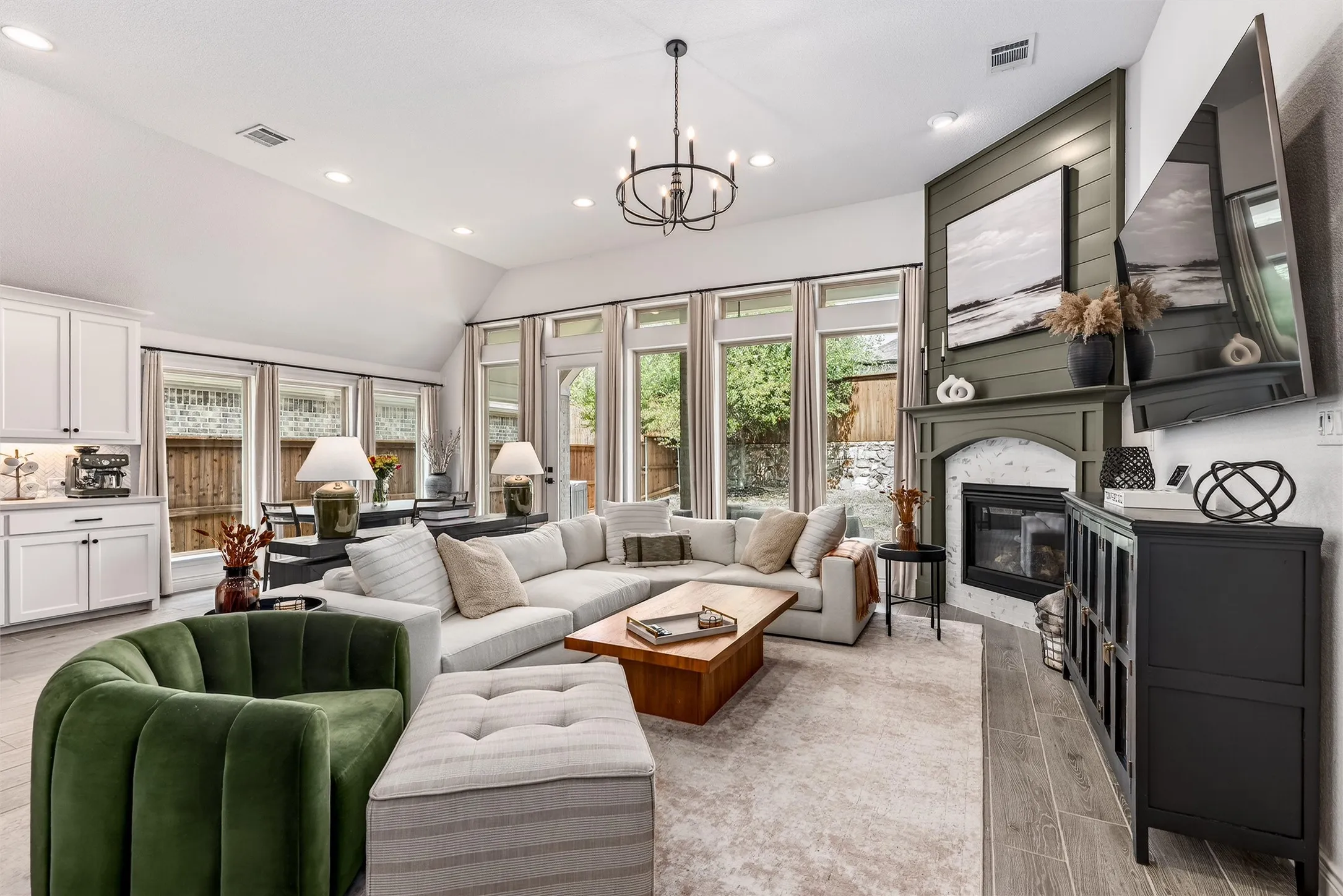 Stunning chefs kitchen with ample storage, quartz countertops, decorative lighting, and a gas cooktop.