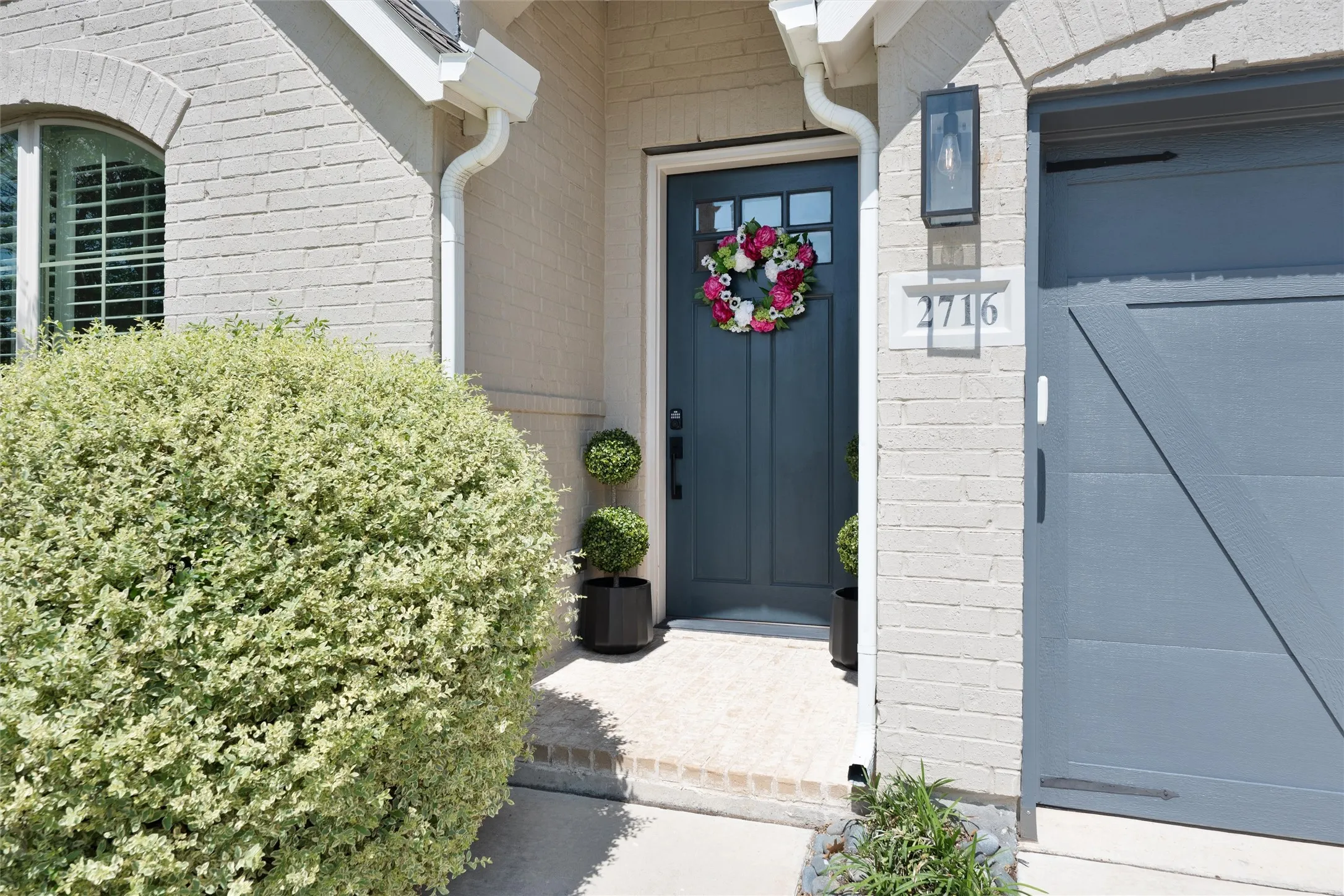 Great curb appeal with a modern door that matches the wood garage doors.