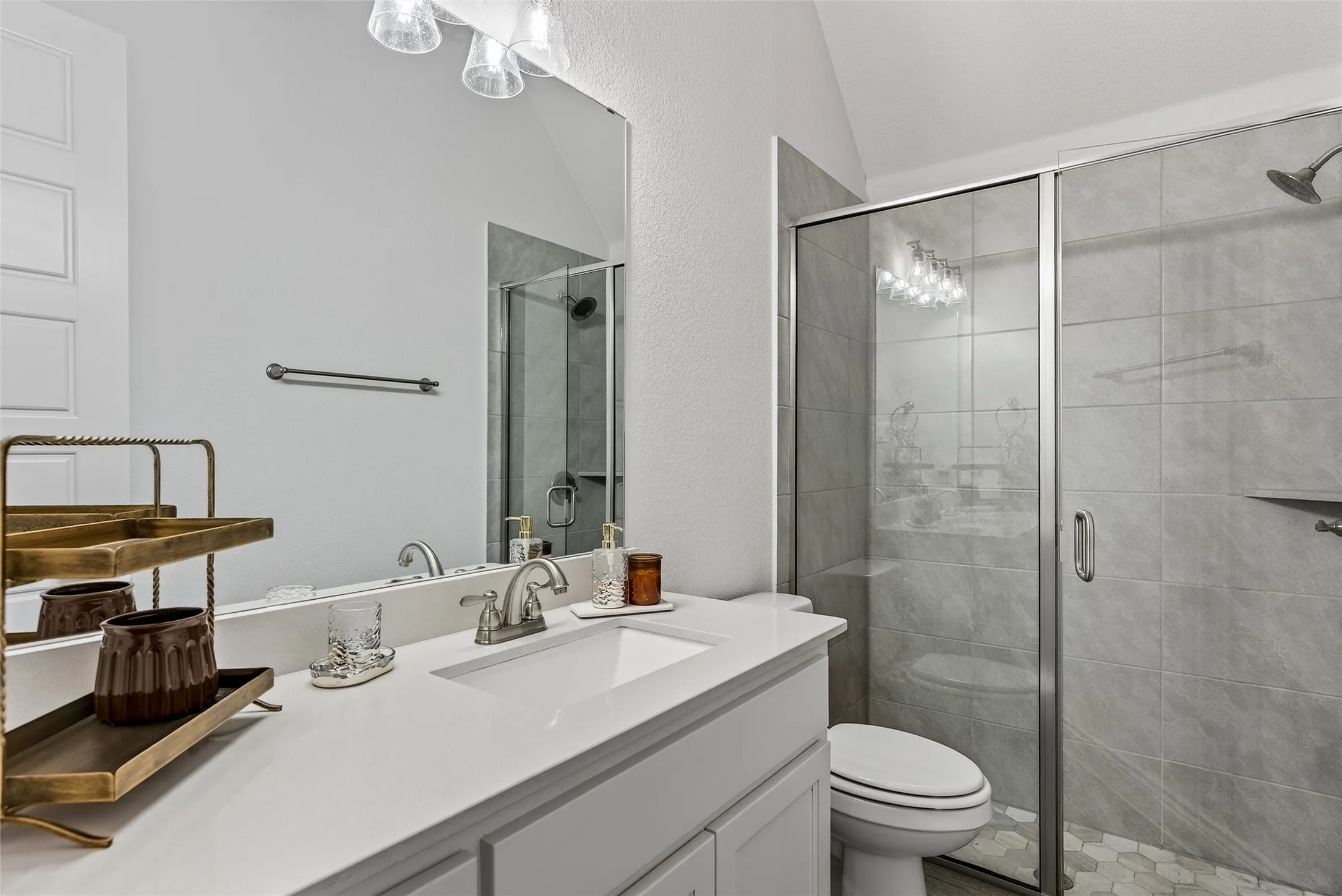 Guest Full bathroom with quartz countertops, & neutral paint.
