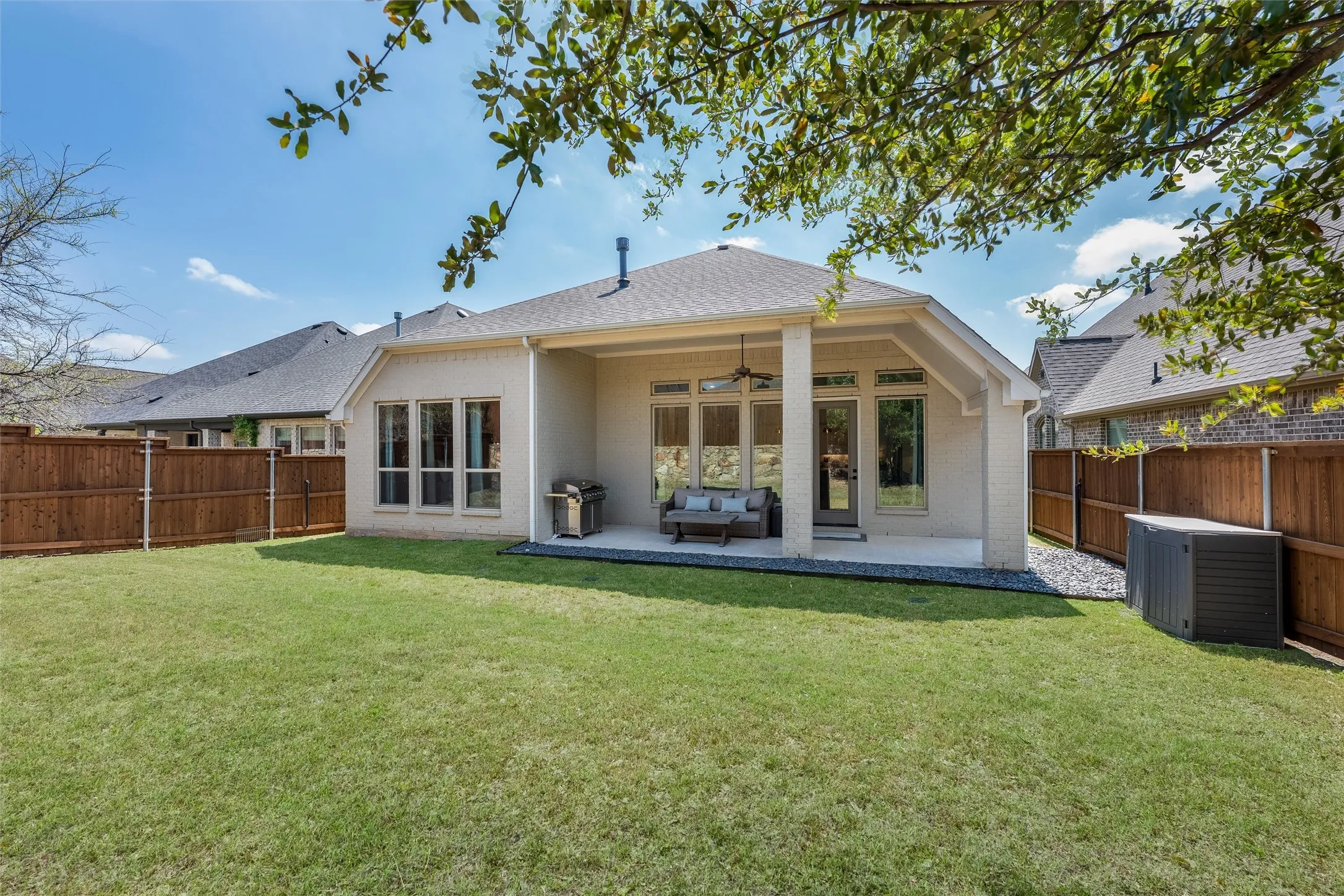 Beautiful landscaped yard with covered patio and a dog run.