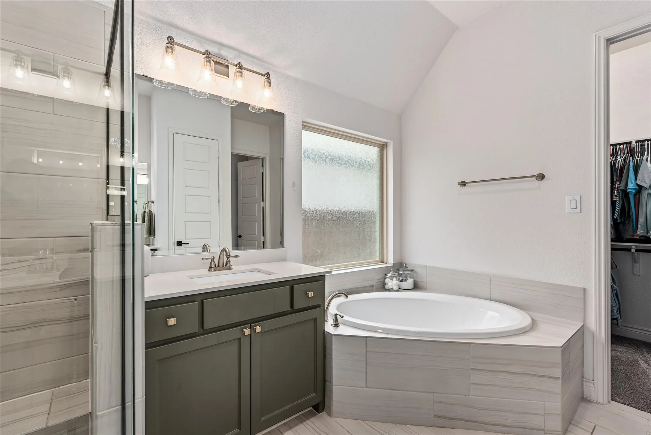 Primary bedroom with large windows and beautiful window treatments that will convey with the home.