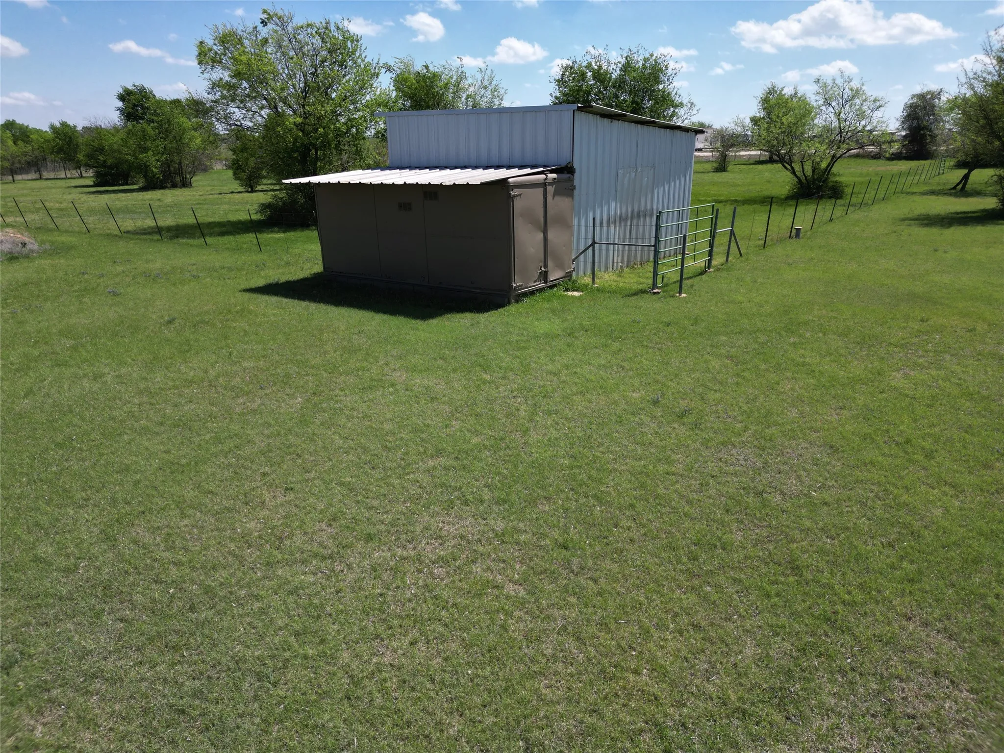View of yard featuring a view of rural / pastoral area and a storage unit