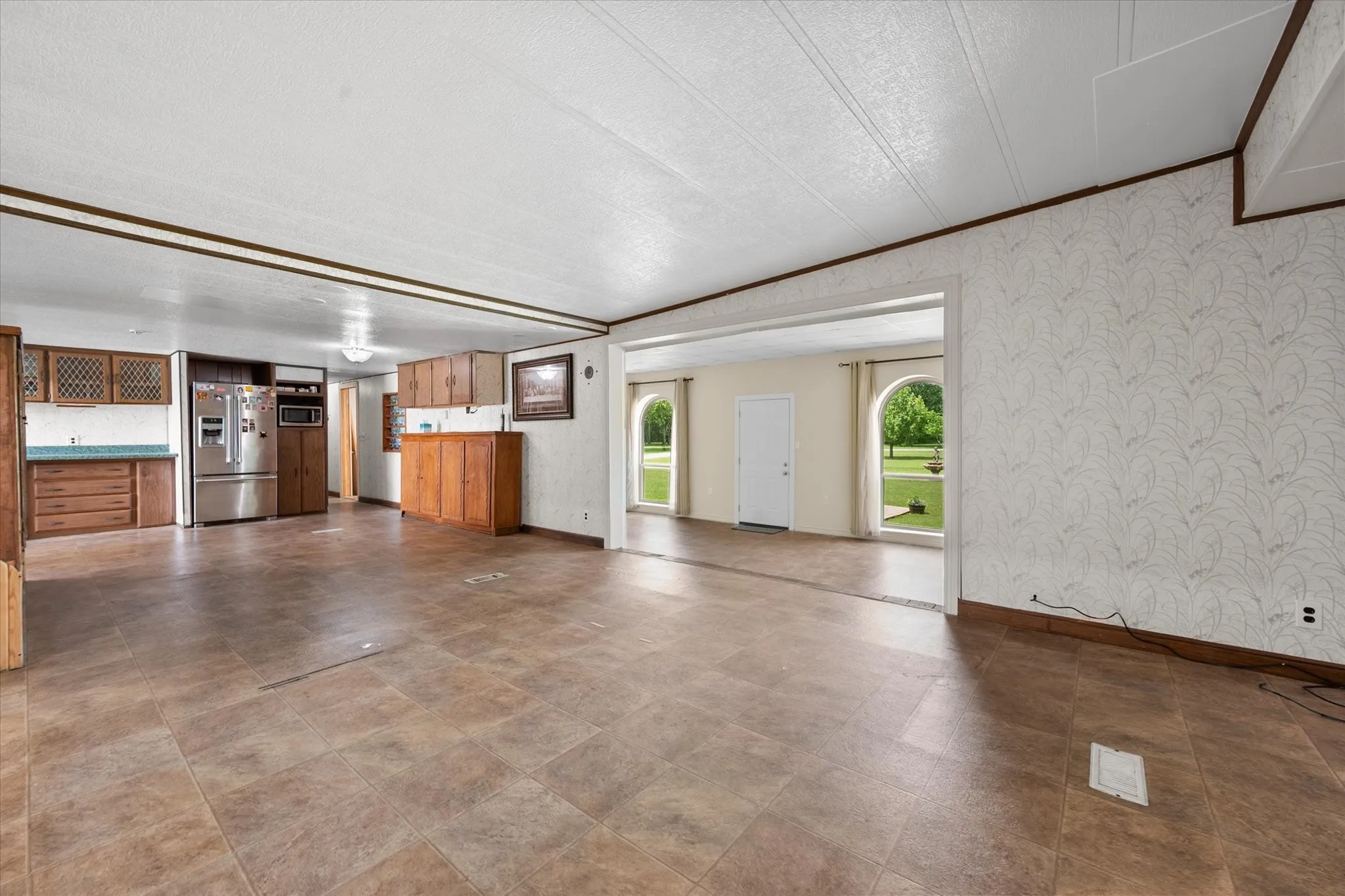 Open-concept interior featuring tiled flooring and wood-finish cabinetry