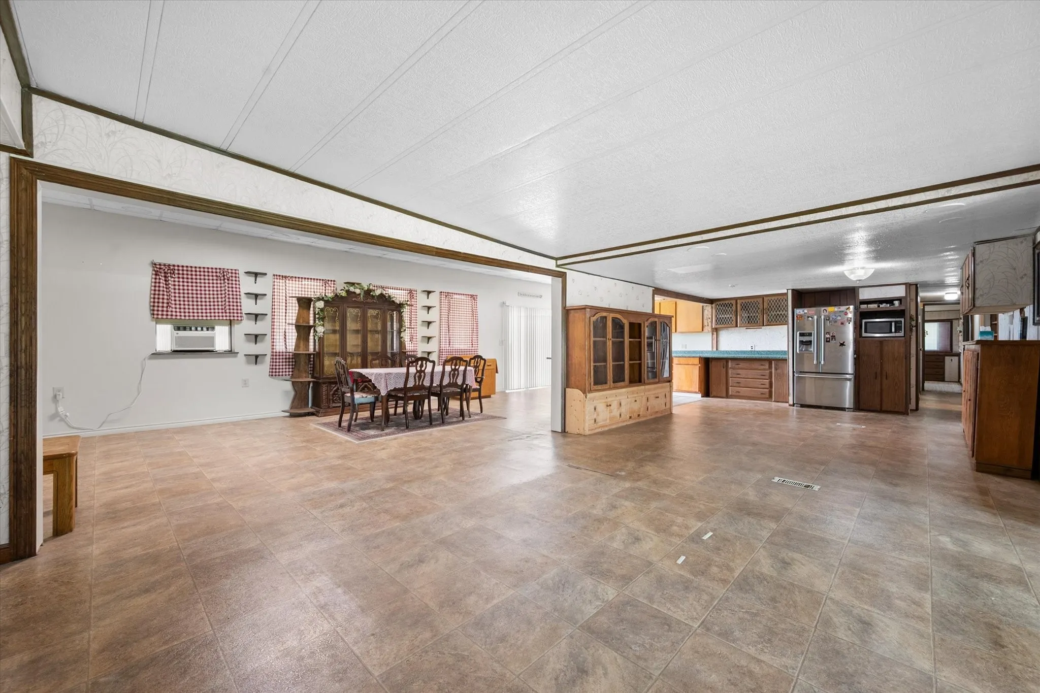 Expansive open-concept interior featuring durable tile flooring throughout
