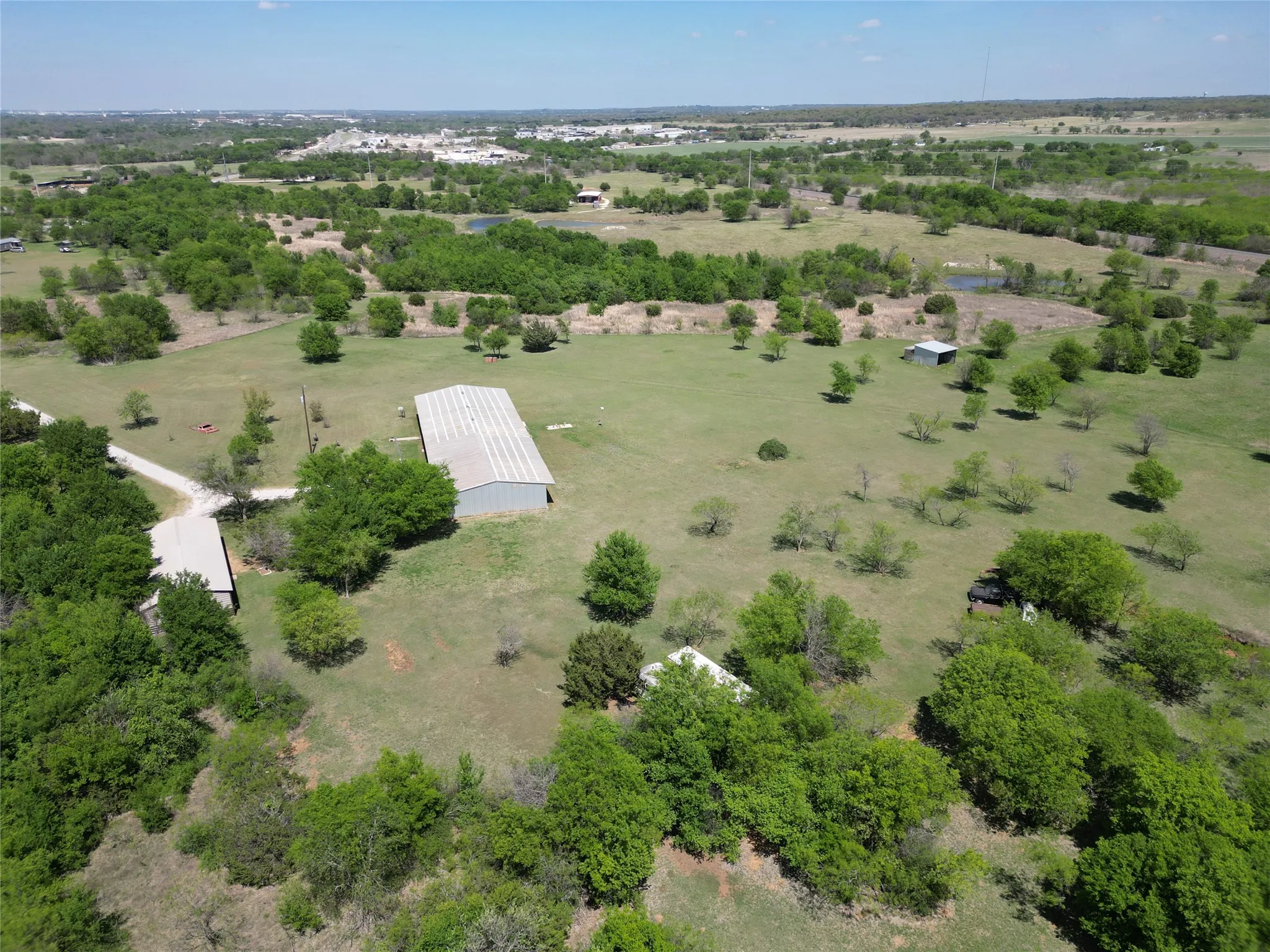 Aerial view of sparsely populated area featuring a tree filled landscape