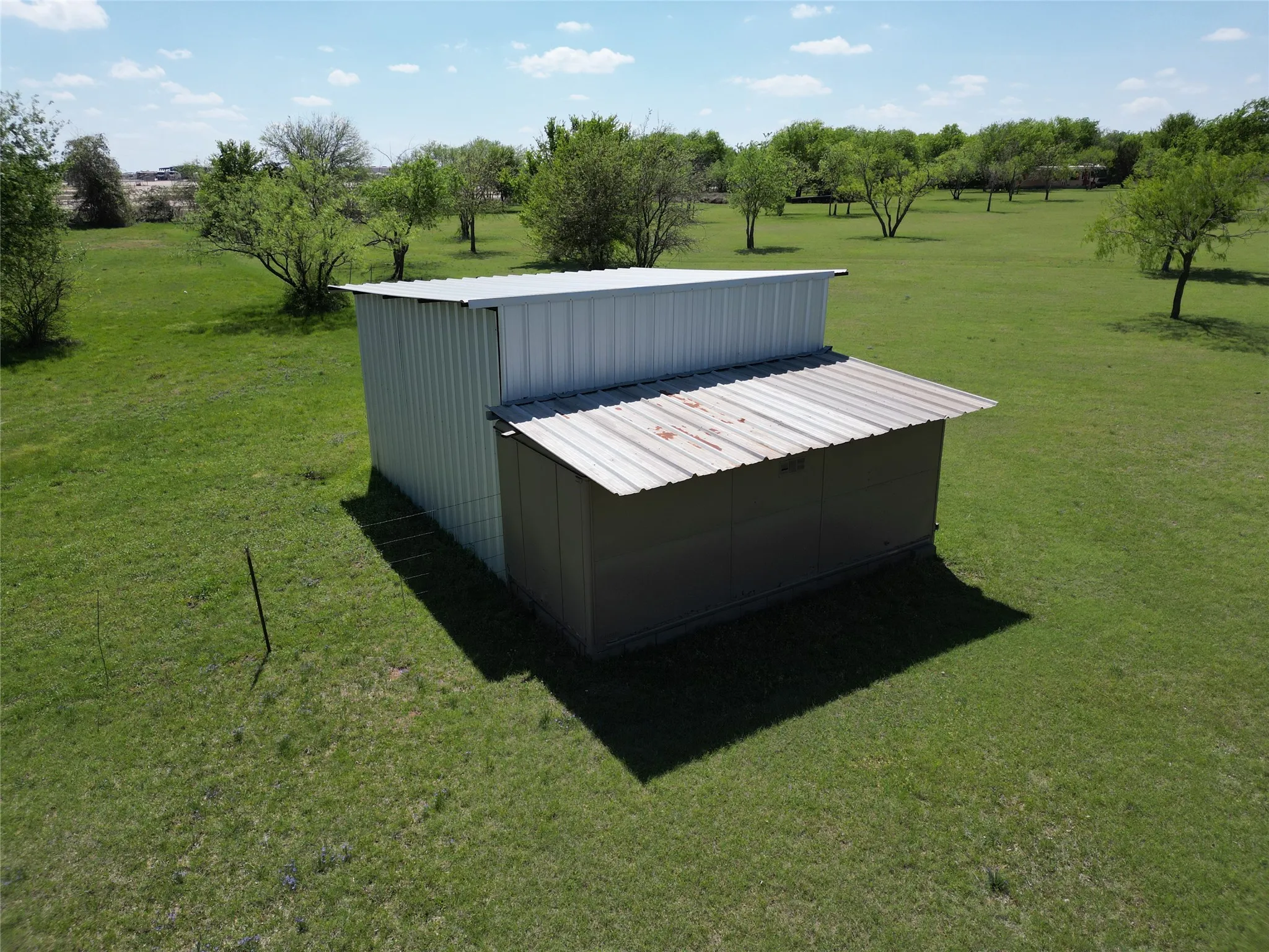 View of green lawn featuring an outdoor structure and an outbuilding