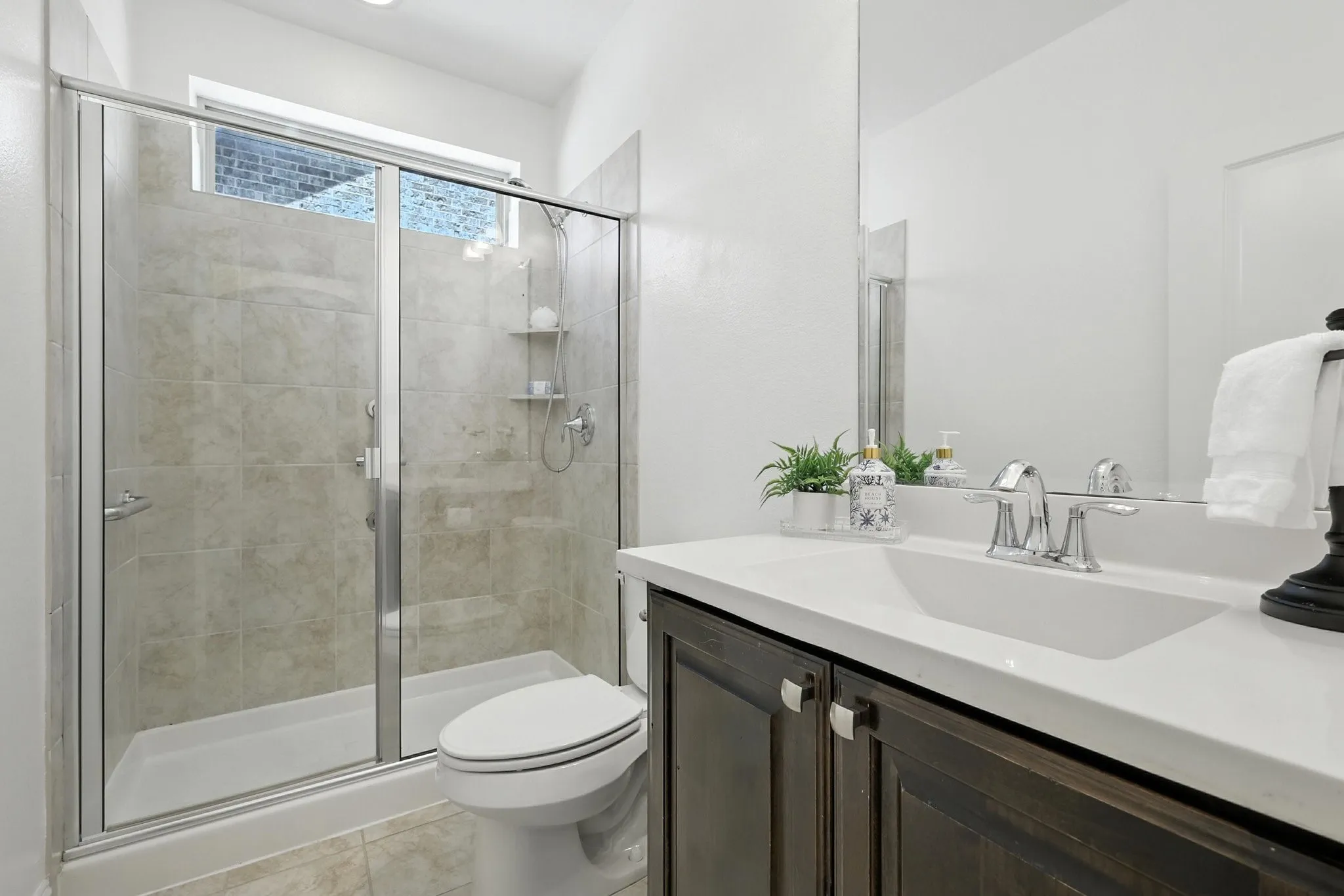 Full Bathroom located at the front of the home adjacent to the Secondary Bedroom downstairs.
