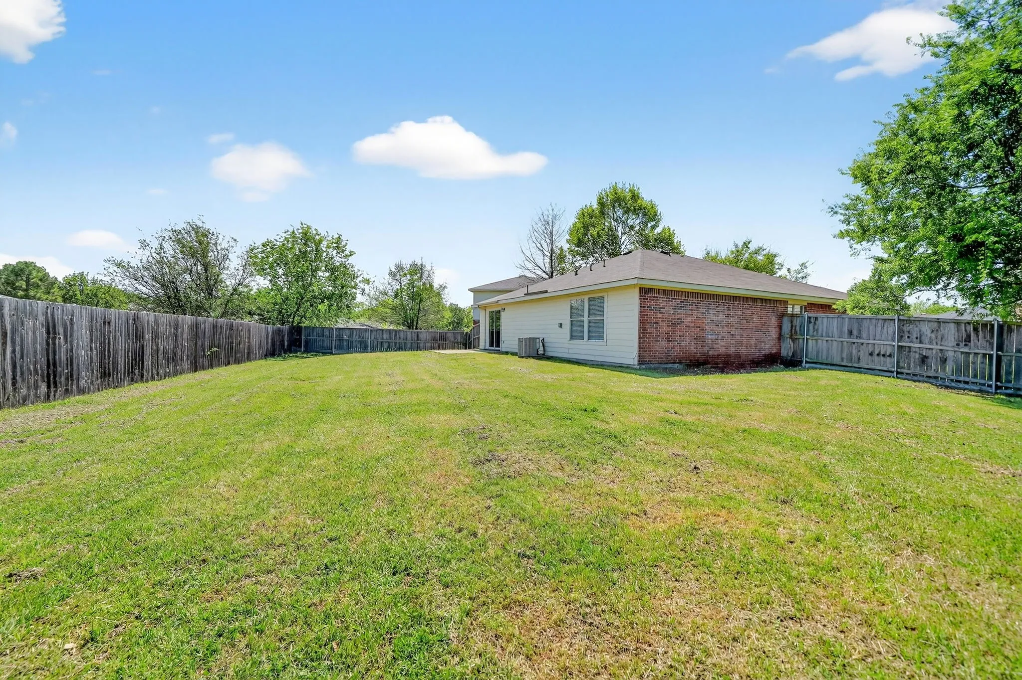 View of fenced backyard