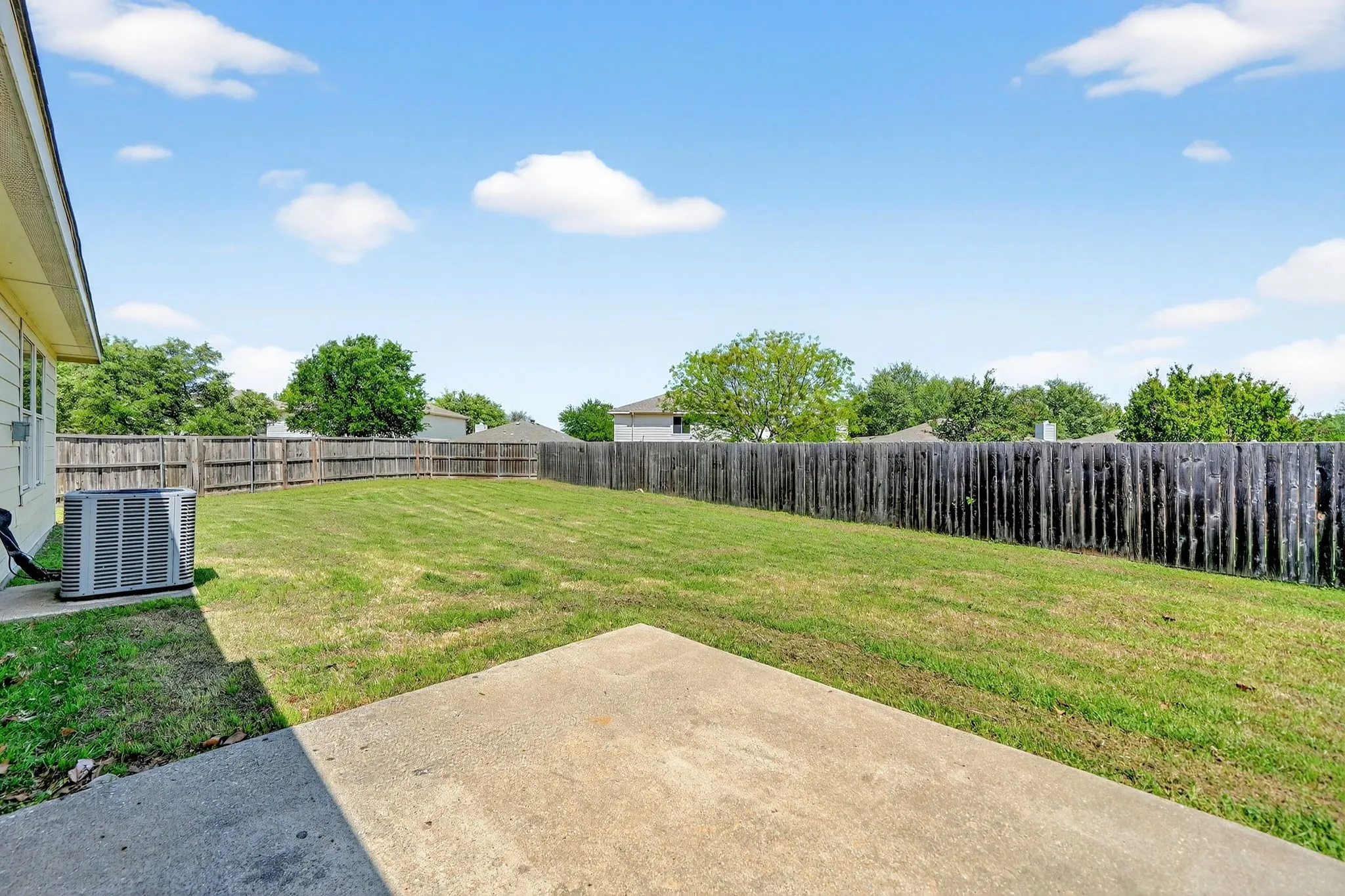 Fenced backyard featuring a patio area